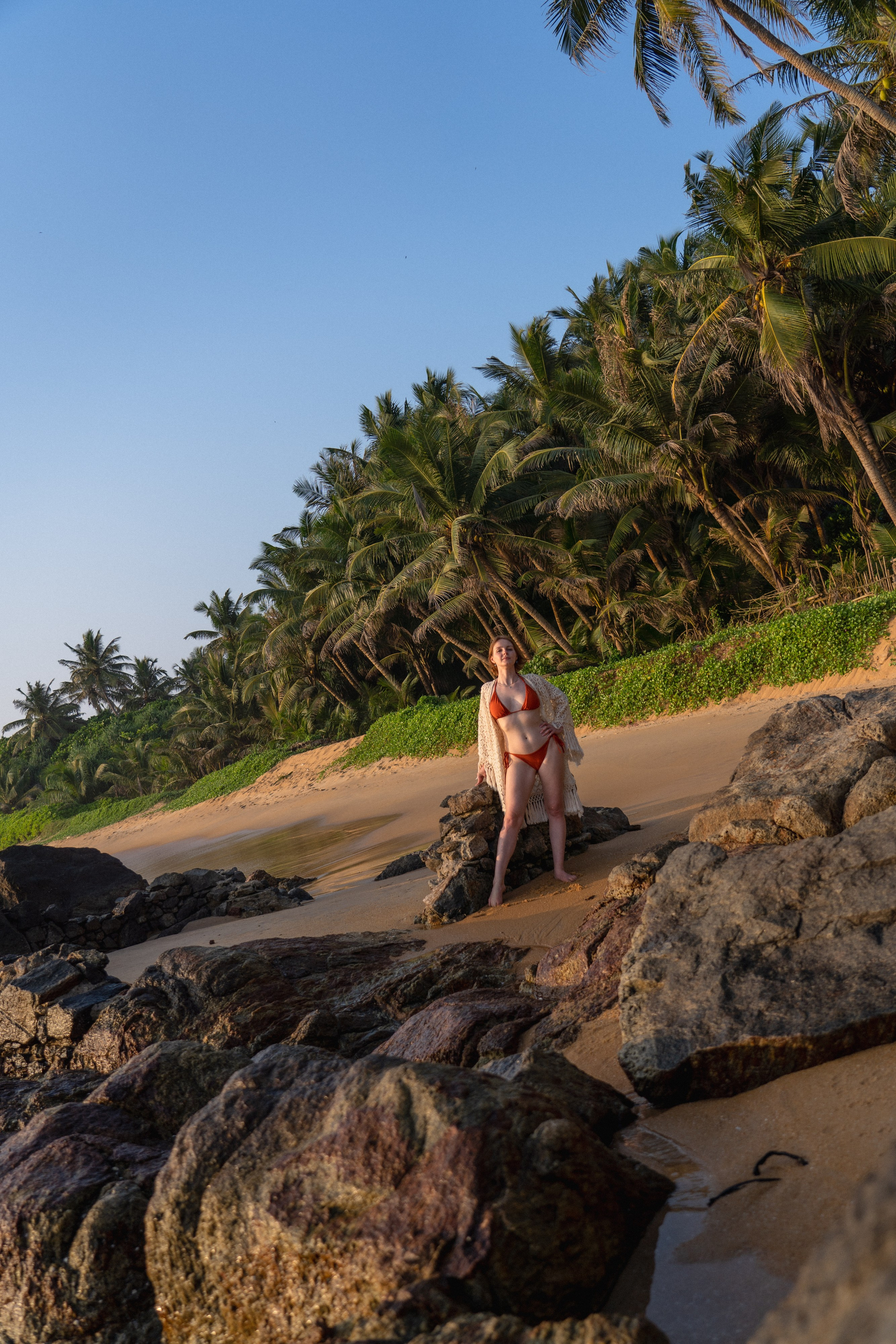 a girl in a red swimsuit against the backdrop of an ocean sunset