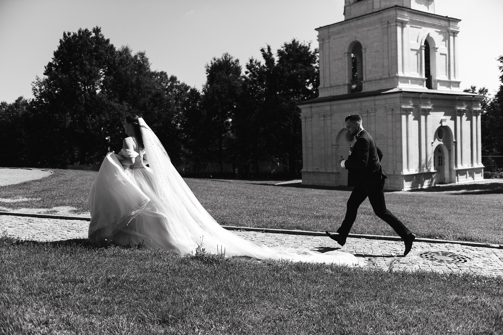 Молодожены бегут по полю.