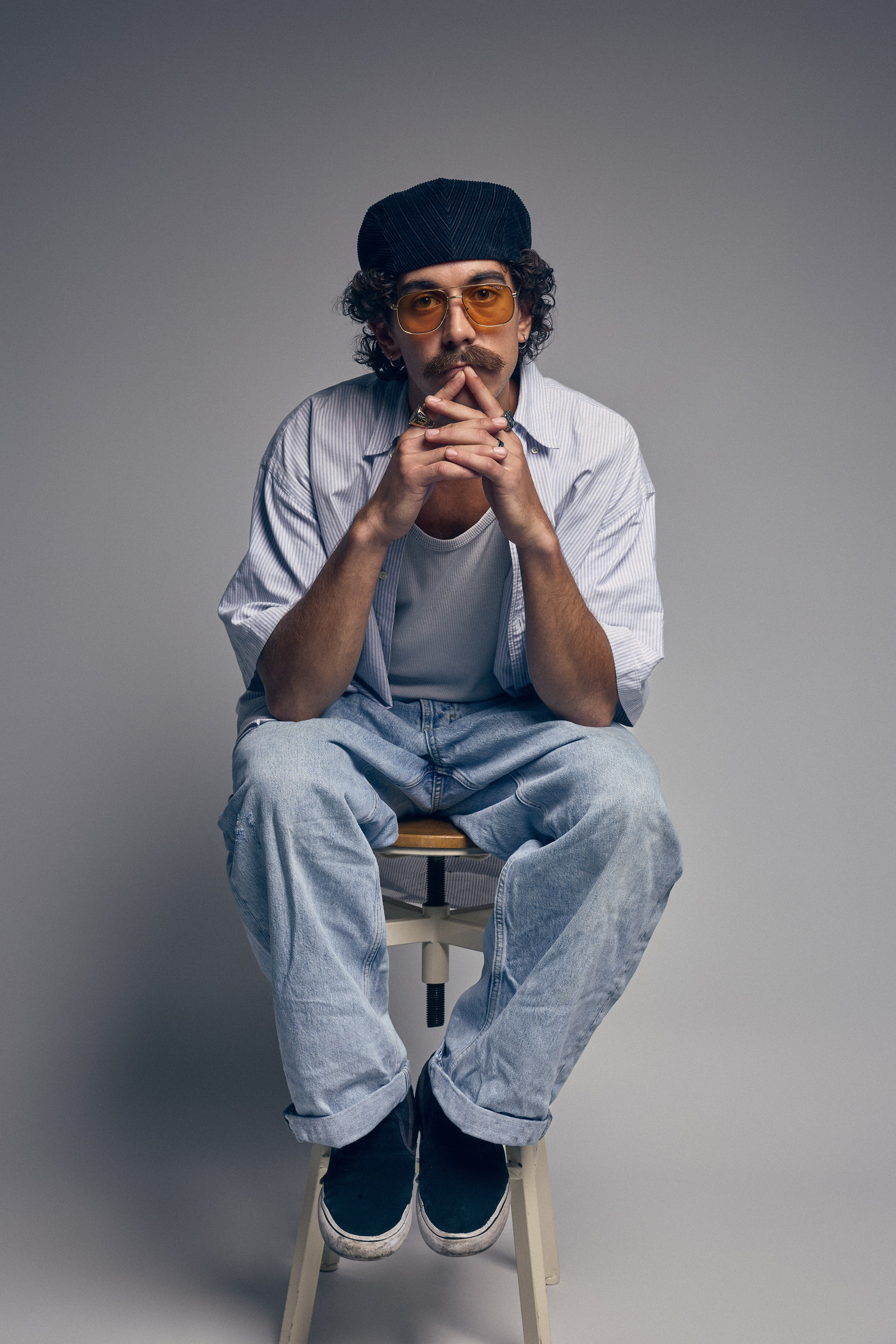 Studio shot of curly haired man with retro glasses