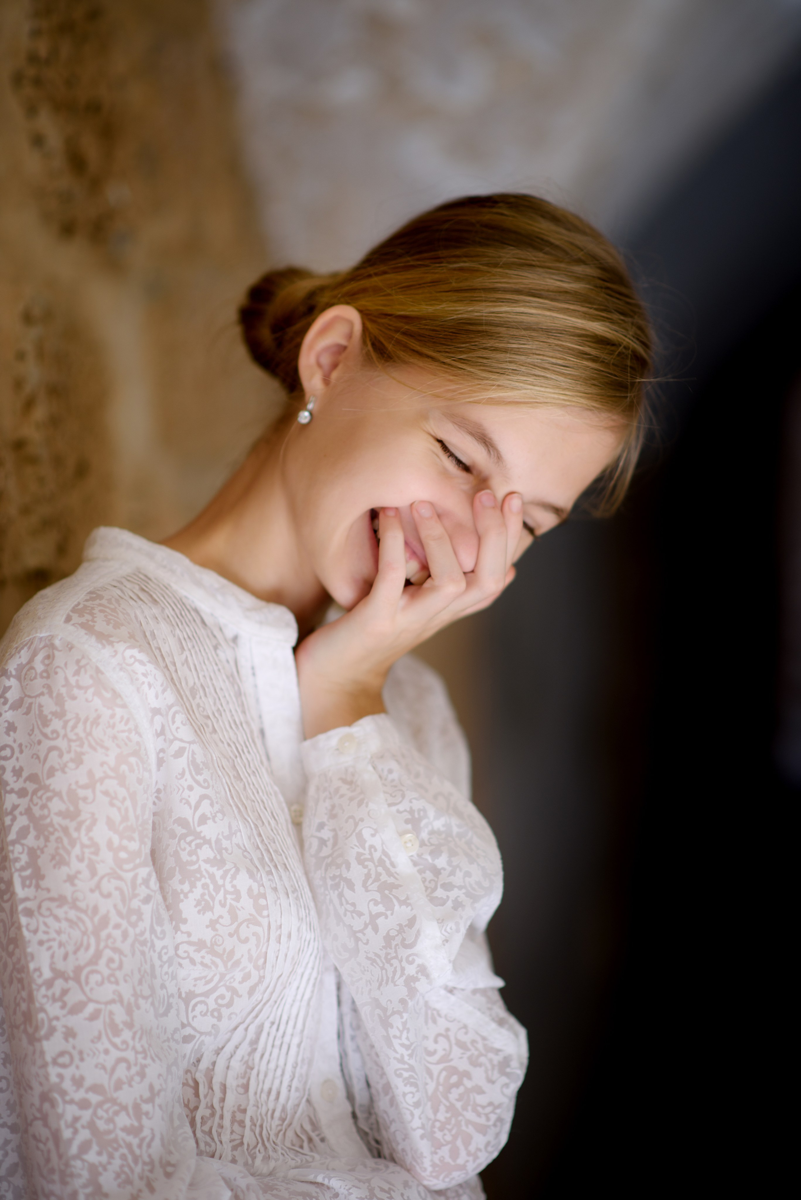 Девочка подросток на фоне старой стены смеется