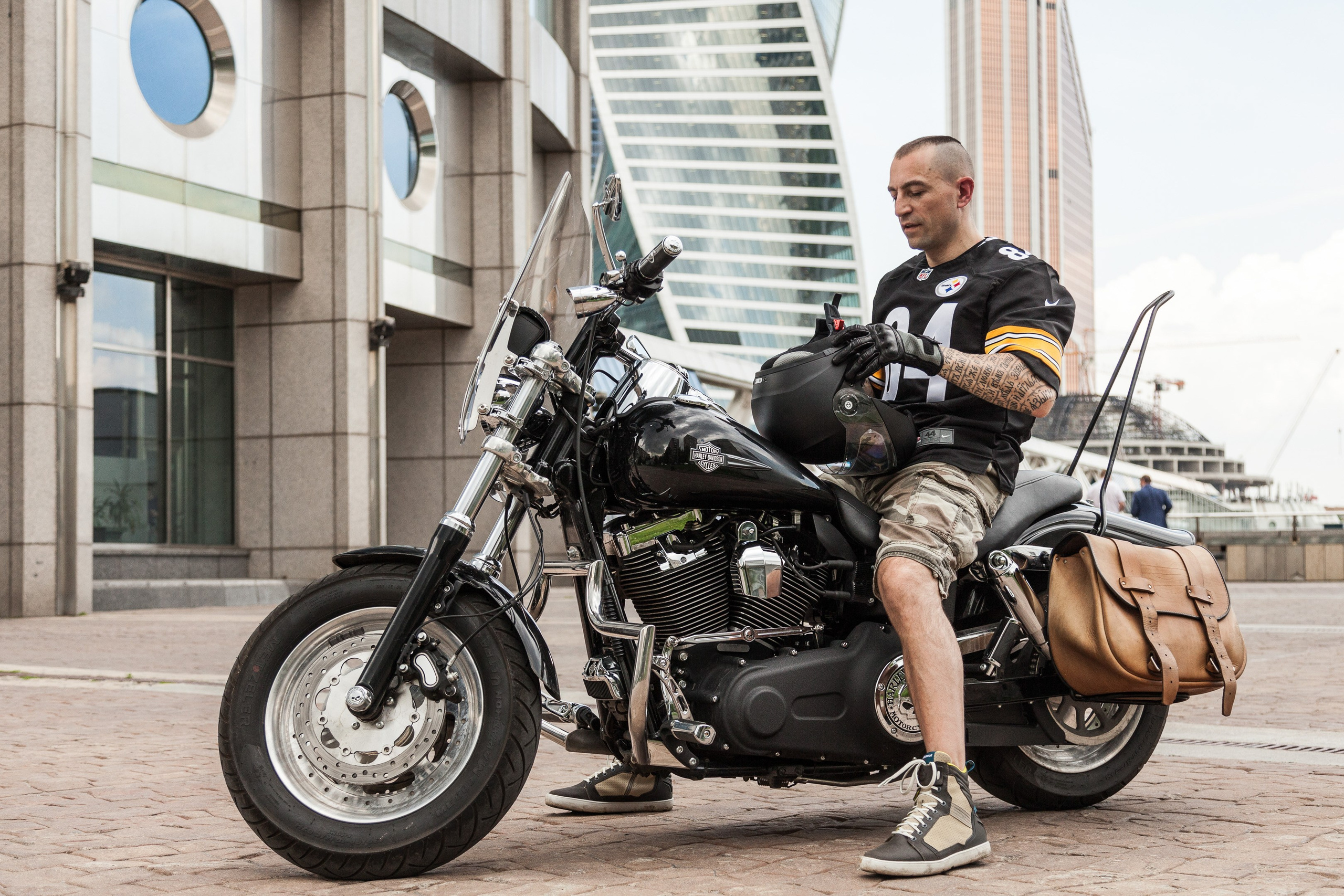Location portrait of a biker on a Harley Davidson motorcycle in city landscape - photographer Andrey Dunin