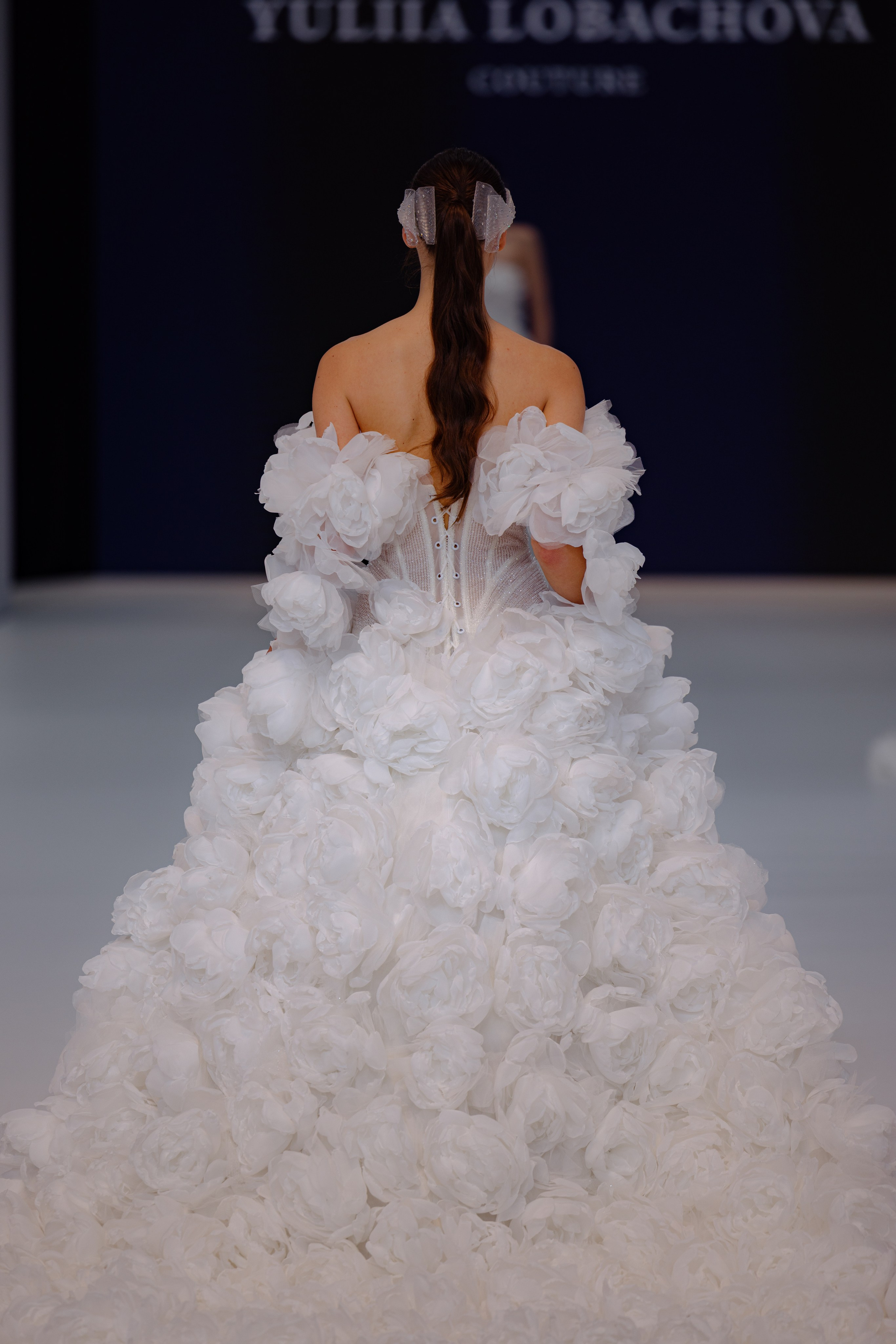 Bridal model posing backstage in dramatic lighting