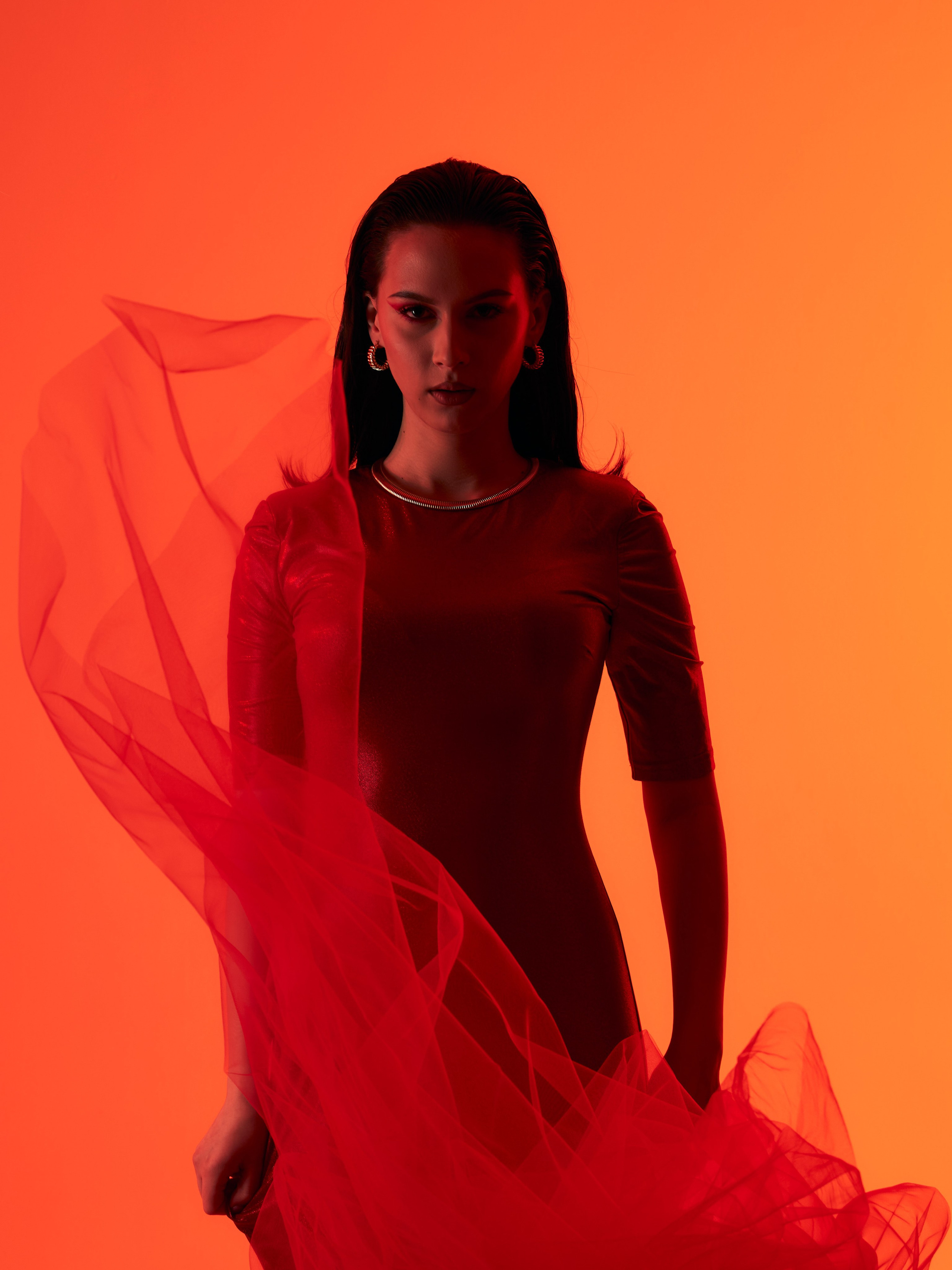 Съёмка с цветным красно-оранжевым светом на белой циклораме 