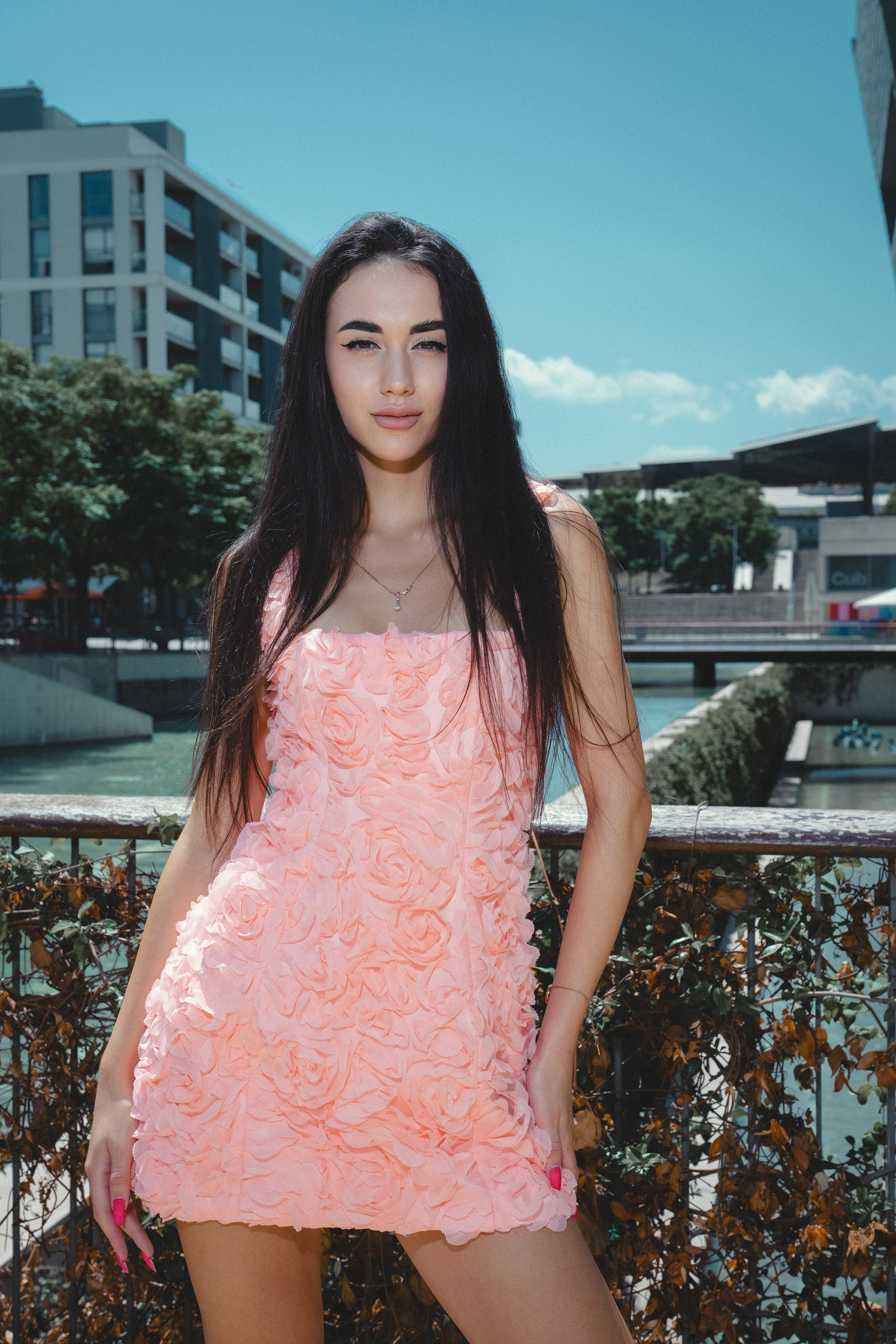 Lady in a blush dress enjoying the golden hour light in Barcelona.
