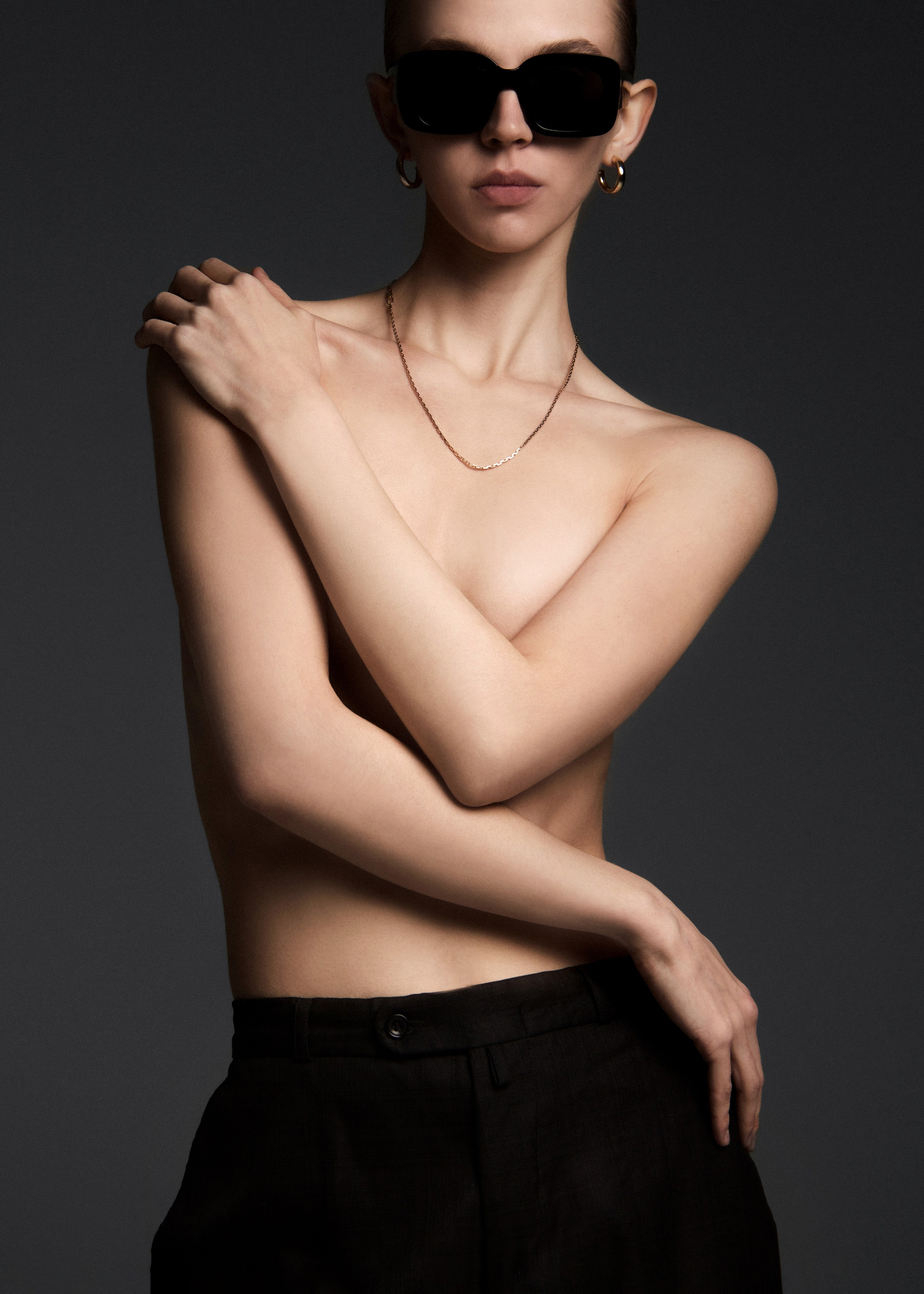 Artistic fashion photography. Model in a nude-style look, tactfully covered. Body aesthetics, naturalness, minimalism.