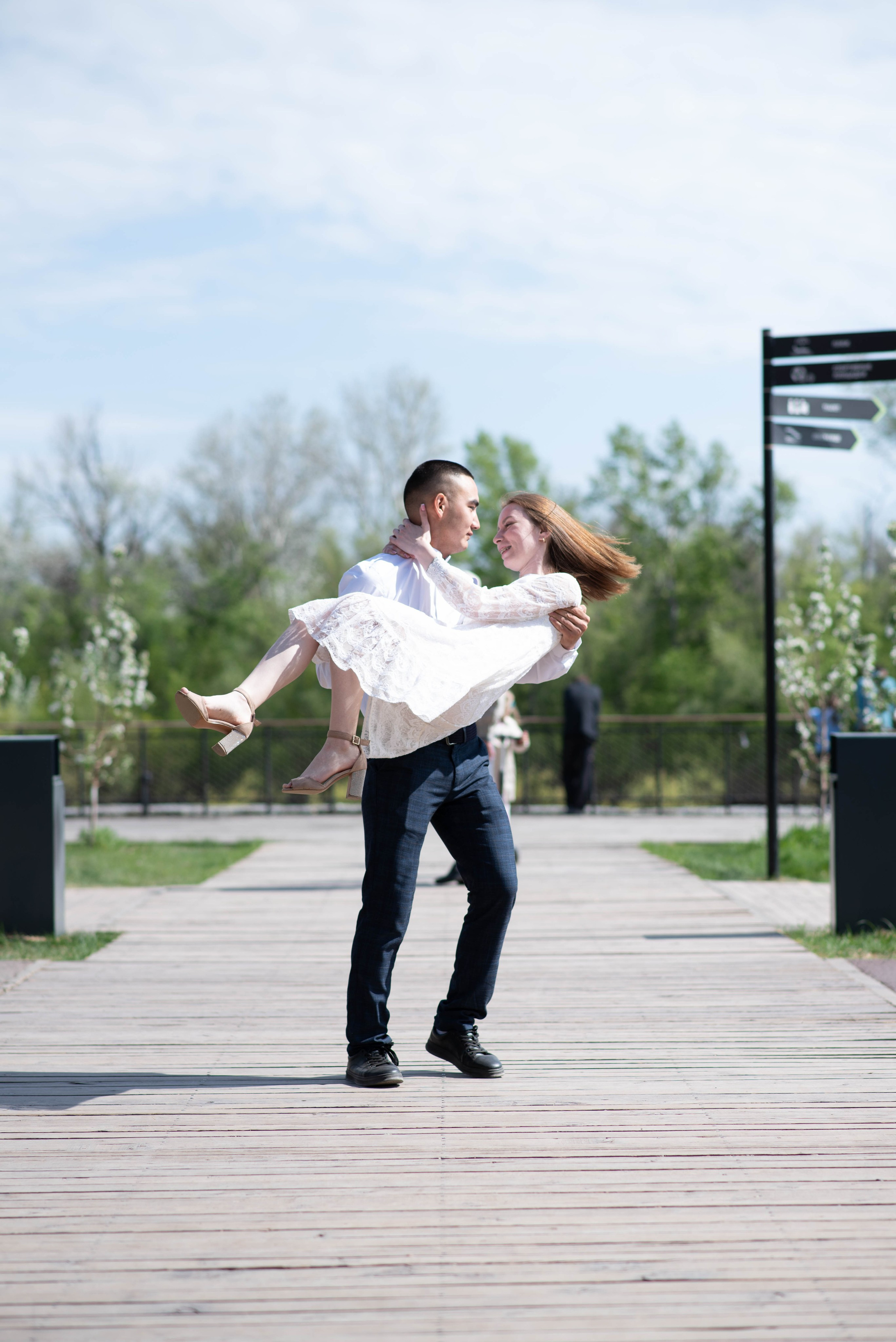 Влюбленный парень кружит девушку на руках.