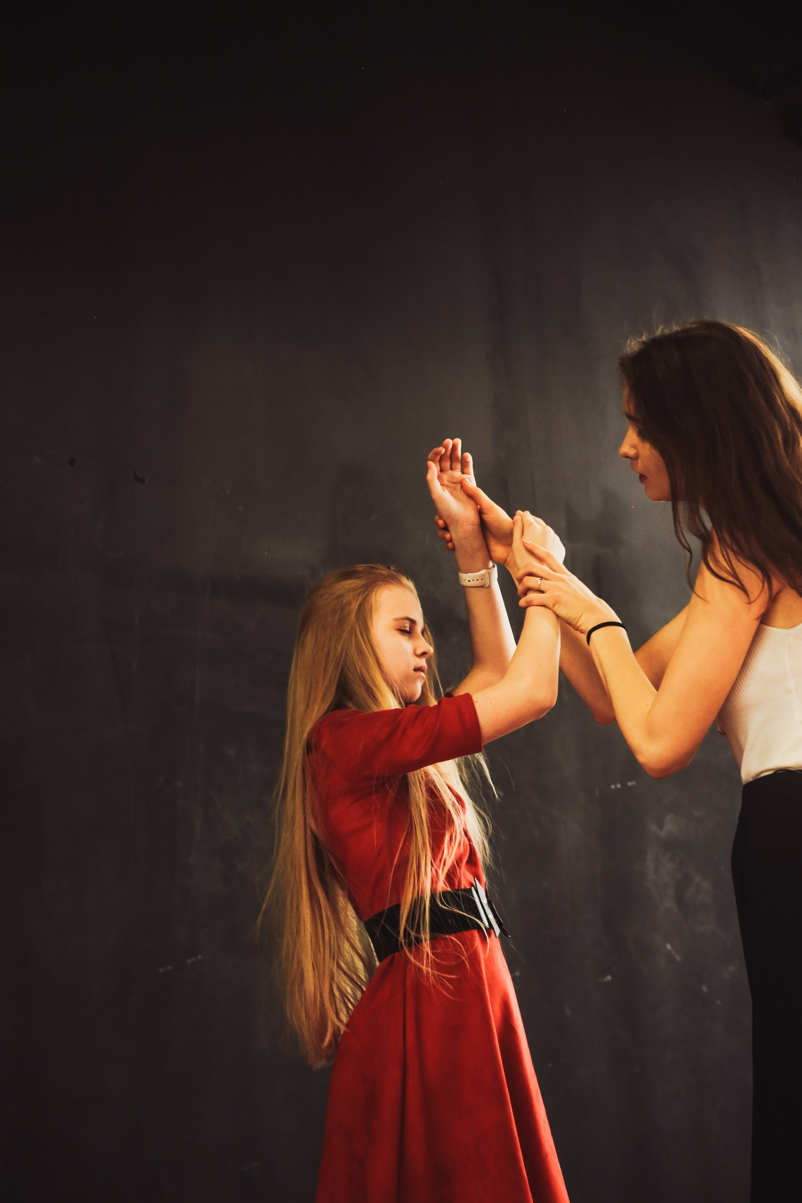 Anasta helping a teenage participant explore hand placement