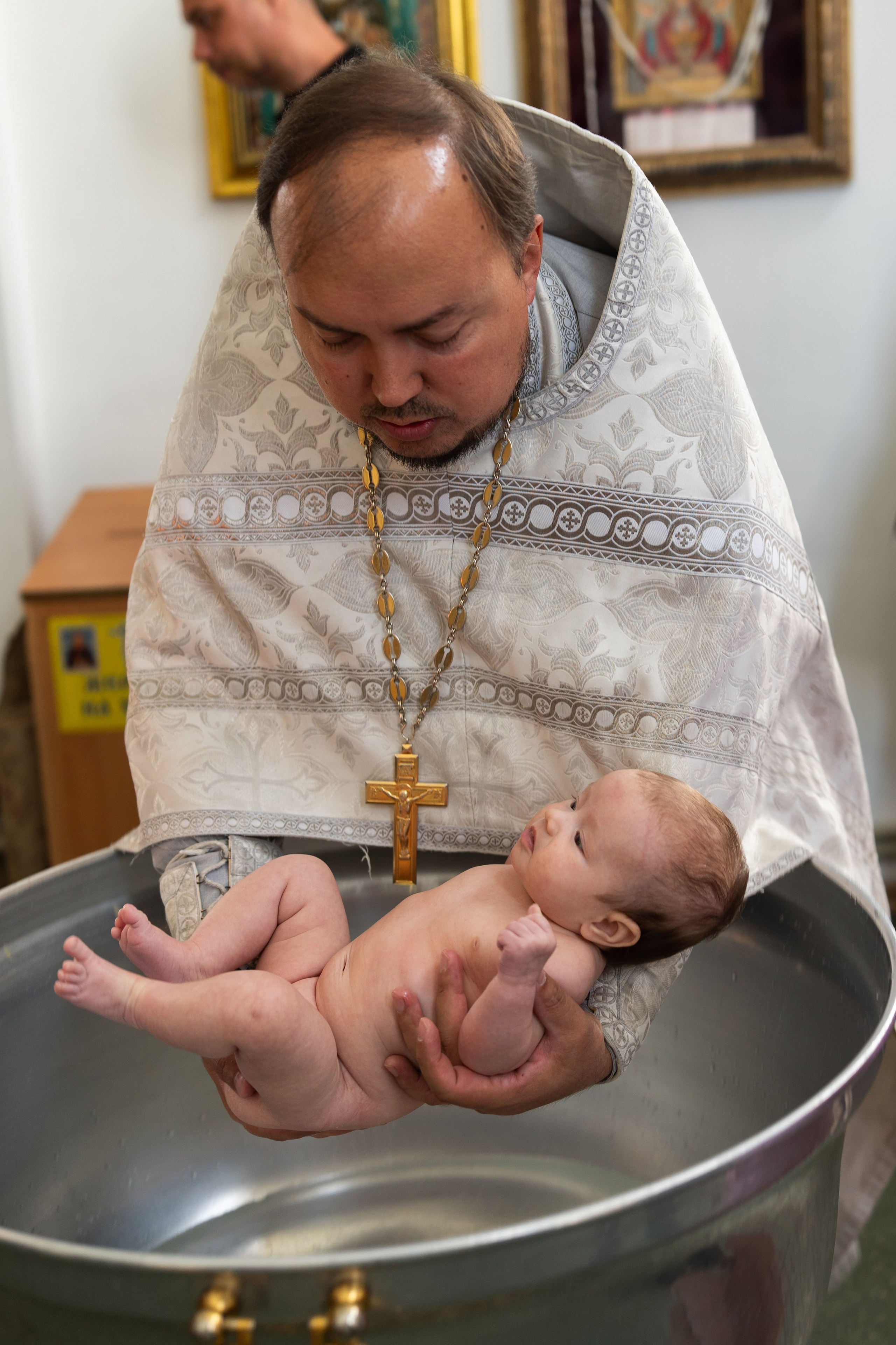 Крещение. Погружение в купель младенца