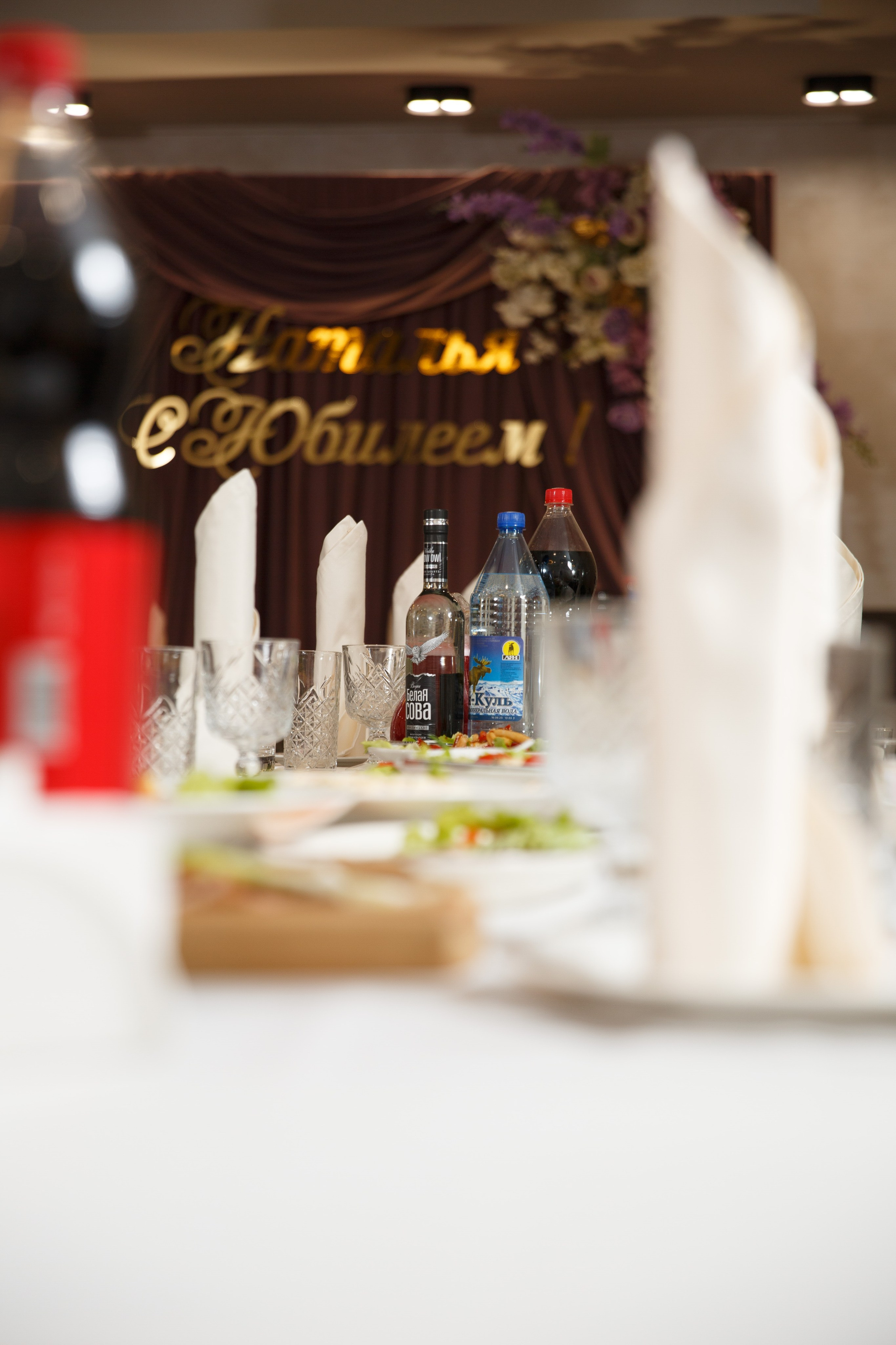 Бокалы и праздничная сервировка на банкетном столе, детали украшения.