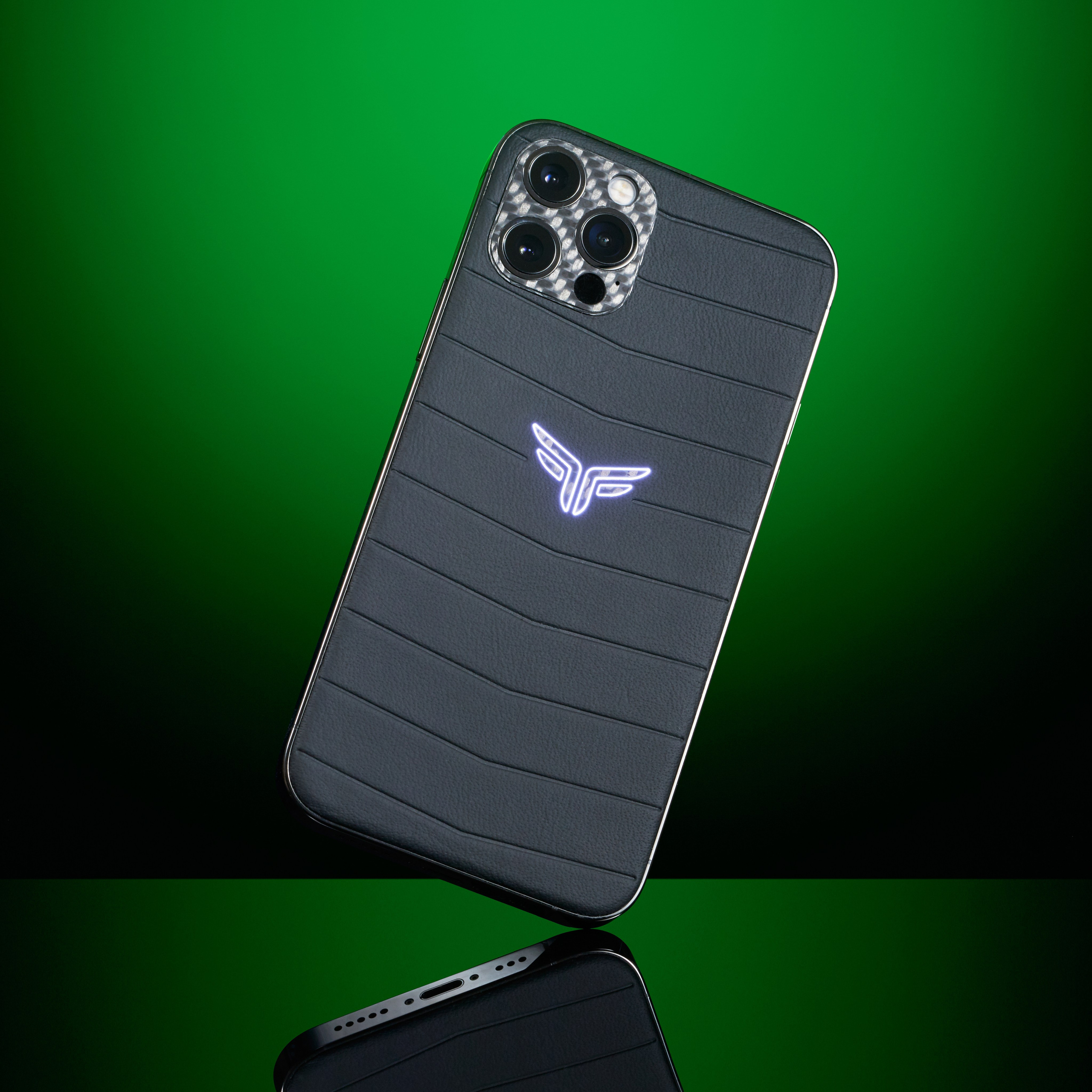 Felix Ferro custom iPhone with glowing FF logo on dark green background - photographer Andrey Dunin