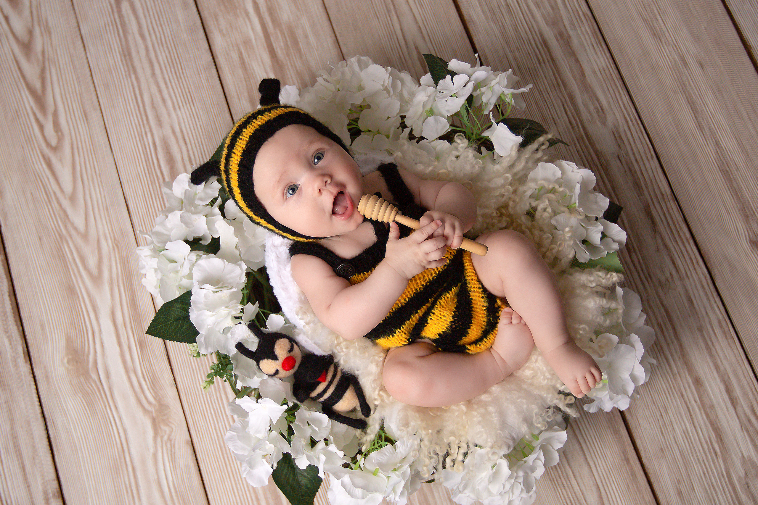 фотосессия малыши до года малышка в костюме пчелки лежит на спинке в корзинке