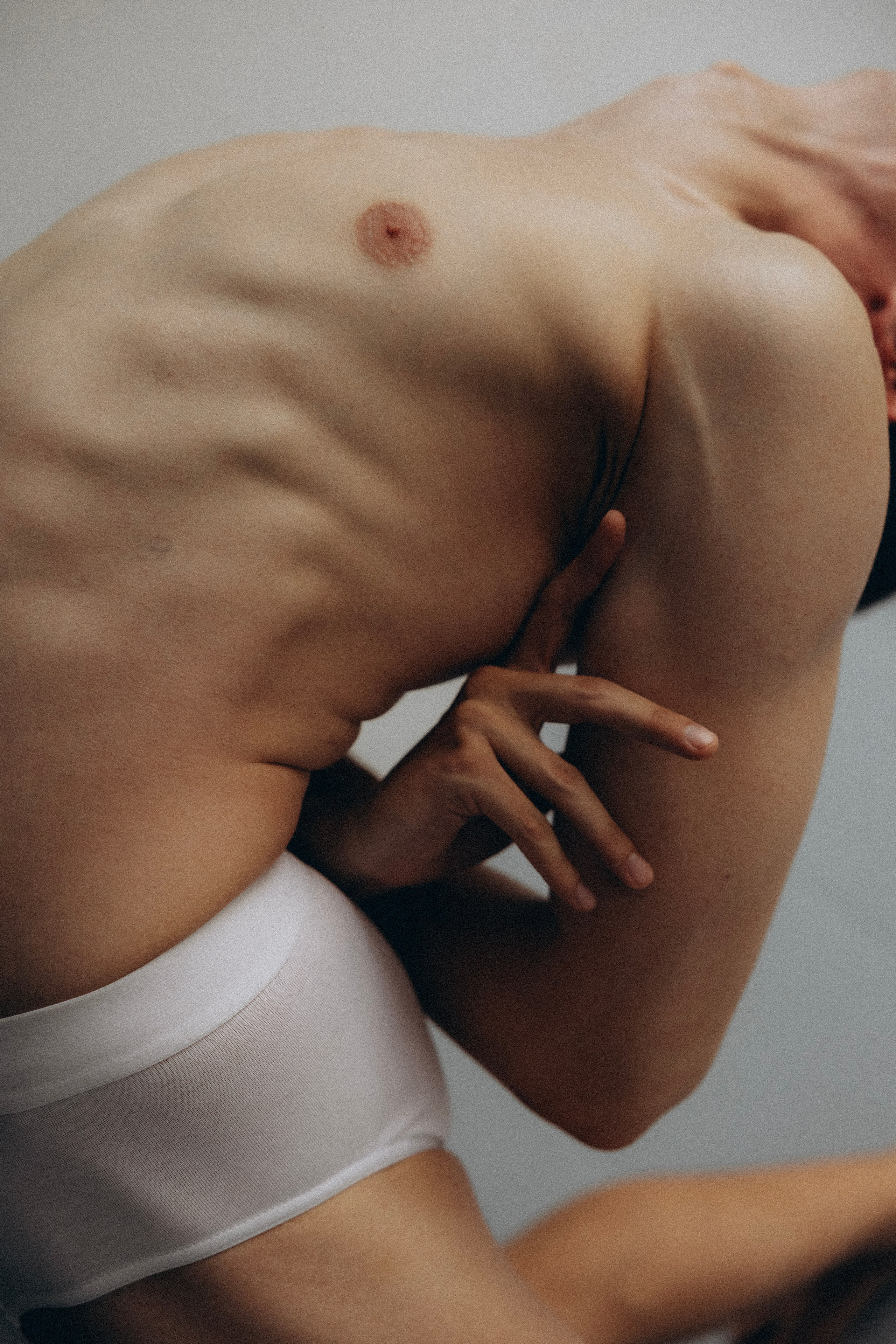 Male dancer stretching on the floor in a contemporary Barcelona photoshoot