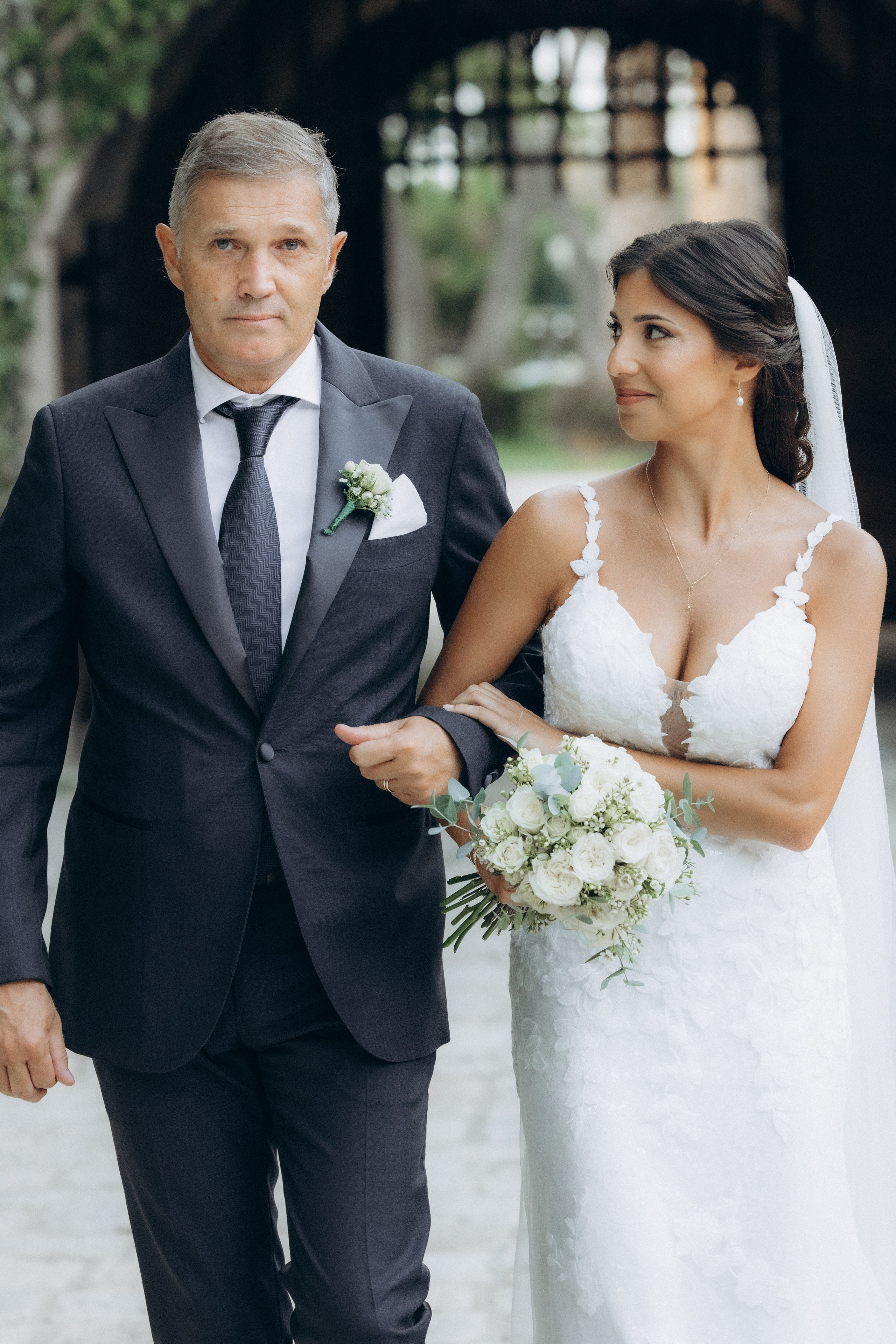 Bride walking with her father before the wedding ceremony