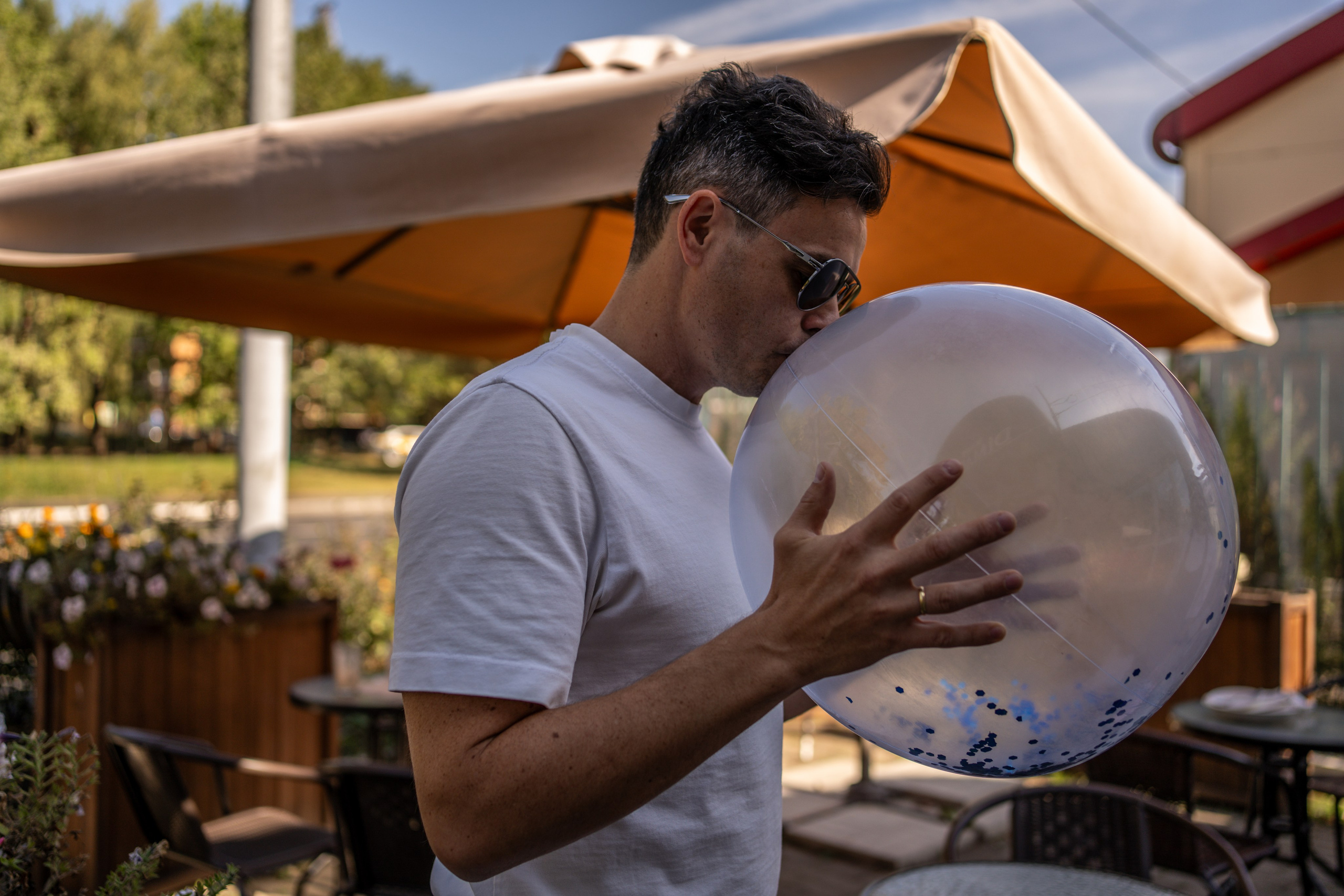 Мужчина надувает шарик