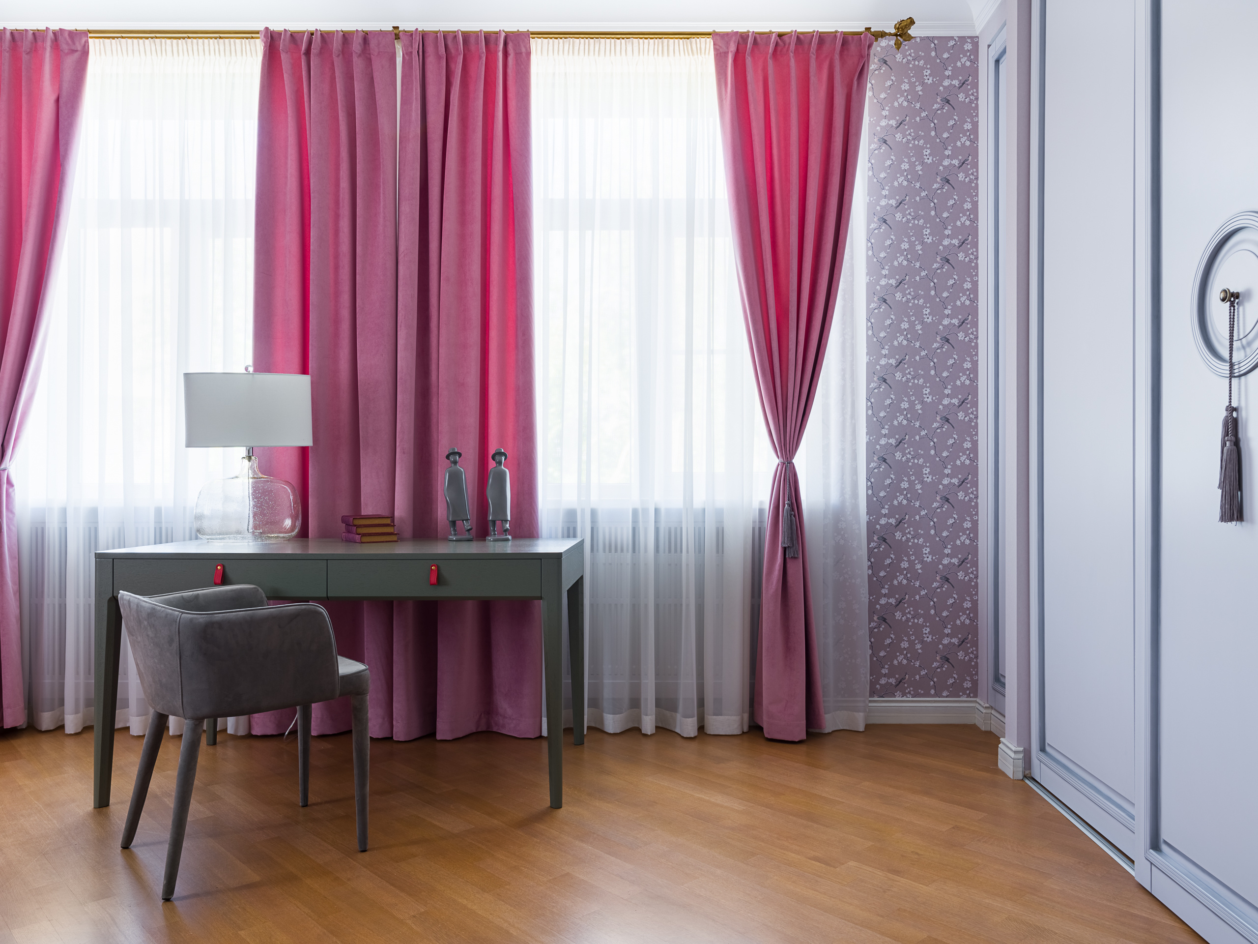 Современная спальня с розовыми бархатными шторами и серым рабочим столом у окна, мягким креслом и лампой из стекла. Уютная атмосфера и продуманные детали дизайна интерьера от Германа Фарени и Надежды Крецкой. Фото Сергея Денисенко.