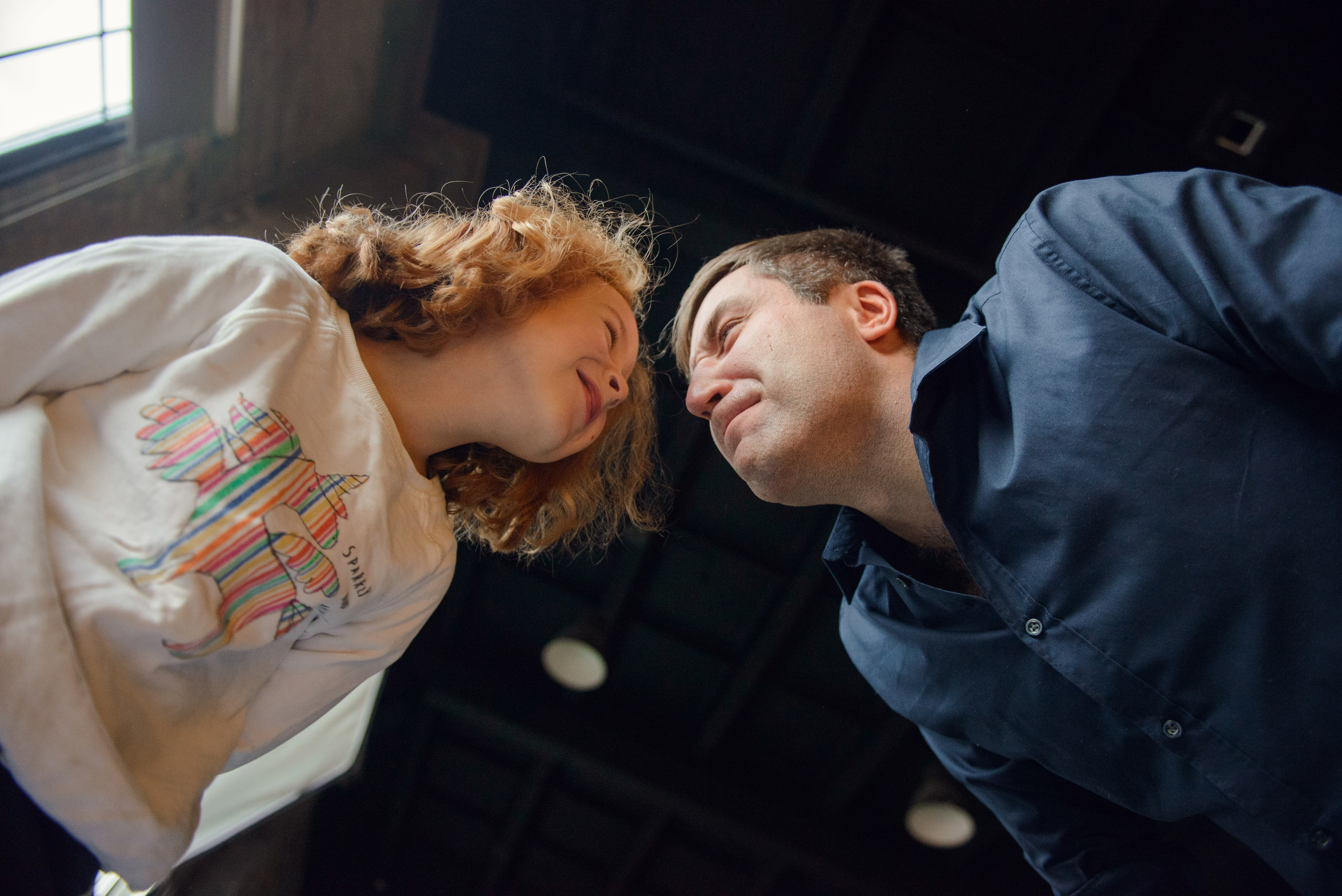 dad and daughter in a dark photo studio