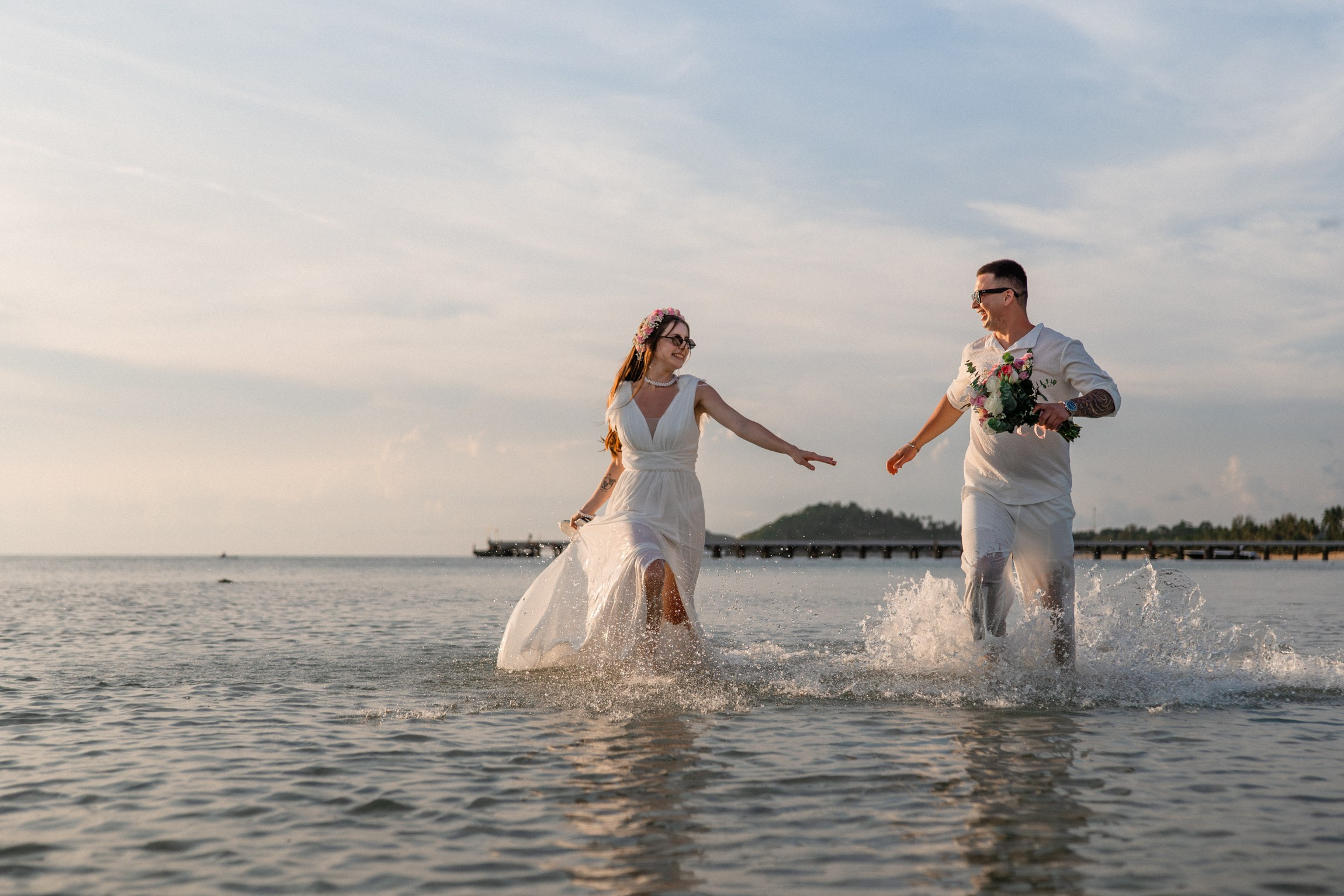 Bride and groom during a romantic beach wedding ceremony on Koh Samui, Thailand, surrounded by tropical scenery and ocean views