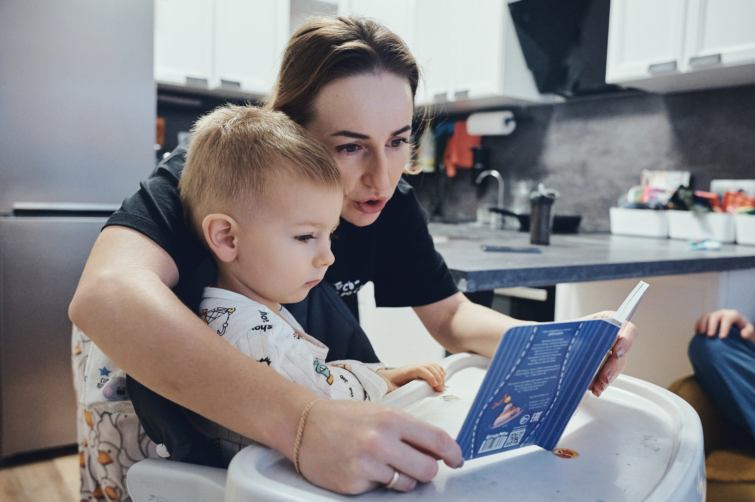 Ребенок читает с мамой книгу