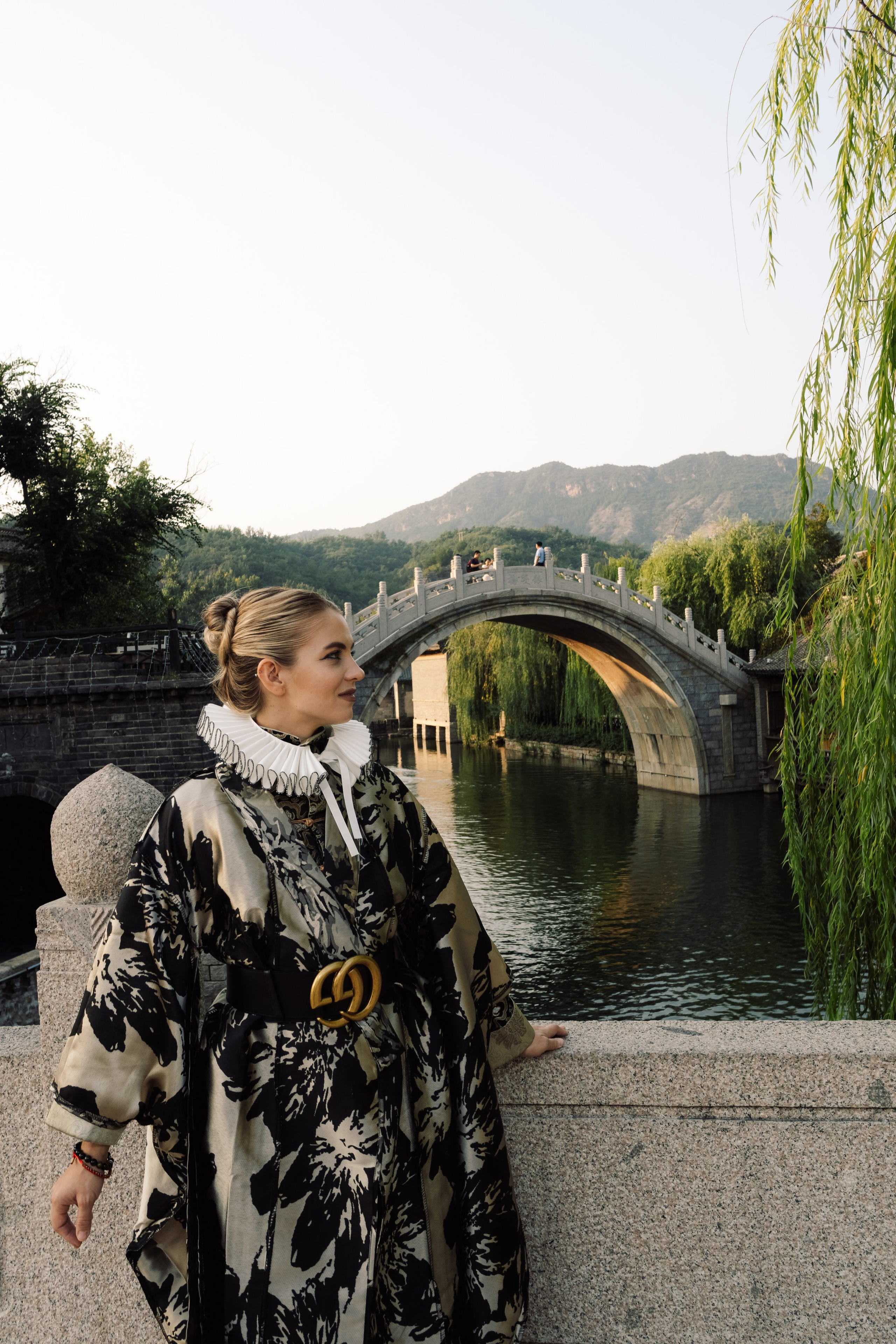 A shot of a model in a fashionable outfit during a night photoshoot in the city of Gubei, China