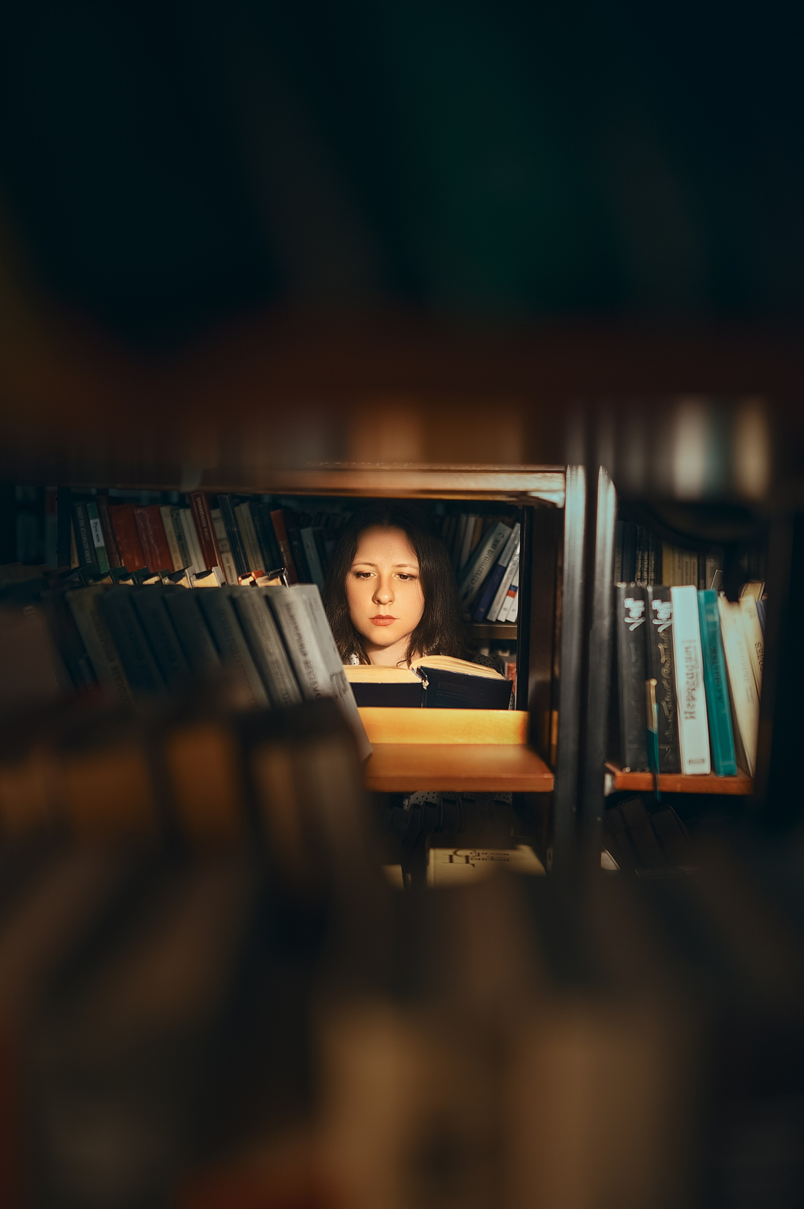 Съёмка в библиотеке (Волгодонск) от Елизаветы Жуйковой. Модель в светлой блузке и тёмной юбке среди книг — атмосфера учёбы и вдохновения.