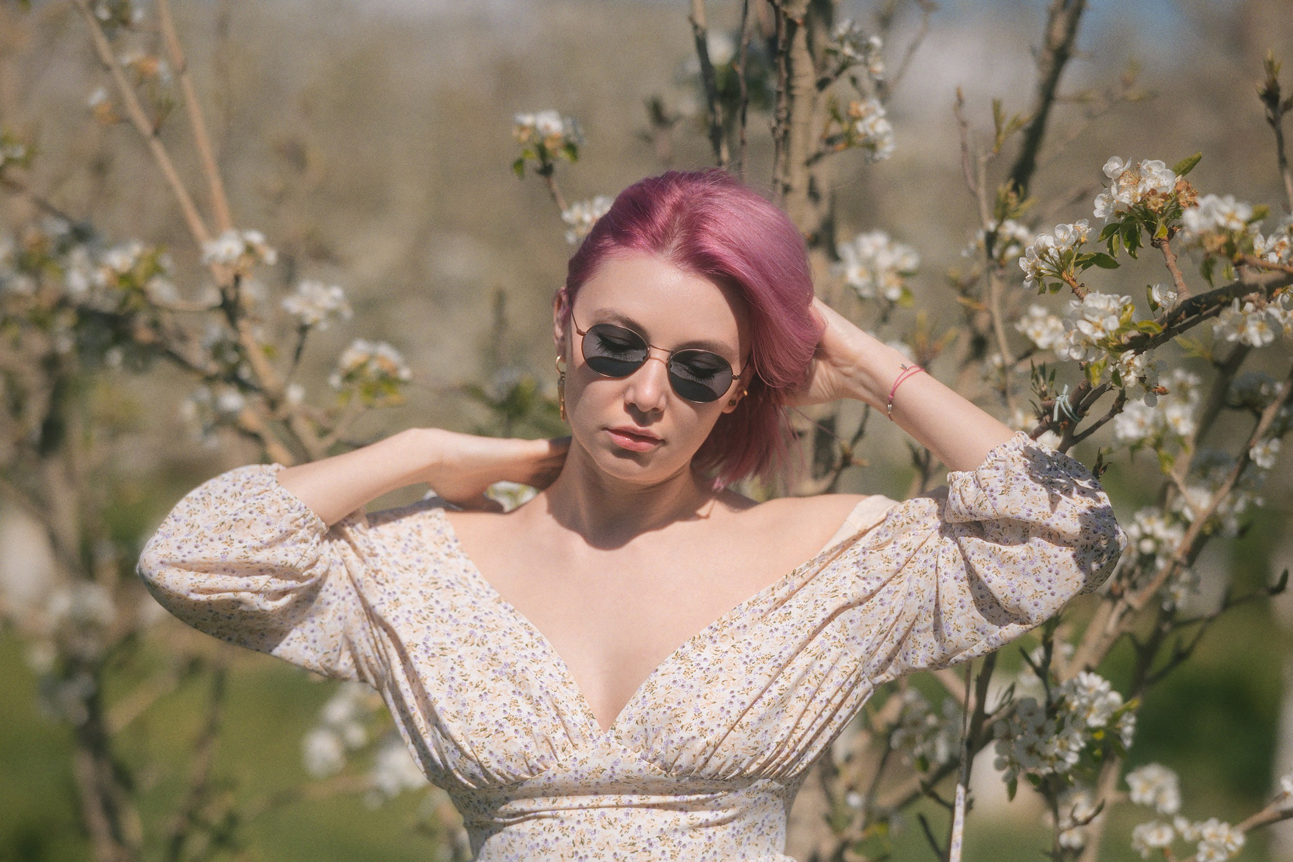 Female portrait in a blooming garden in Barcelona, romantic outdoor photoshoot
