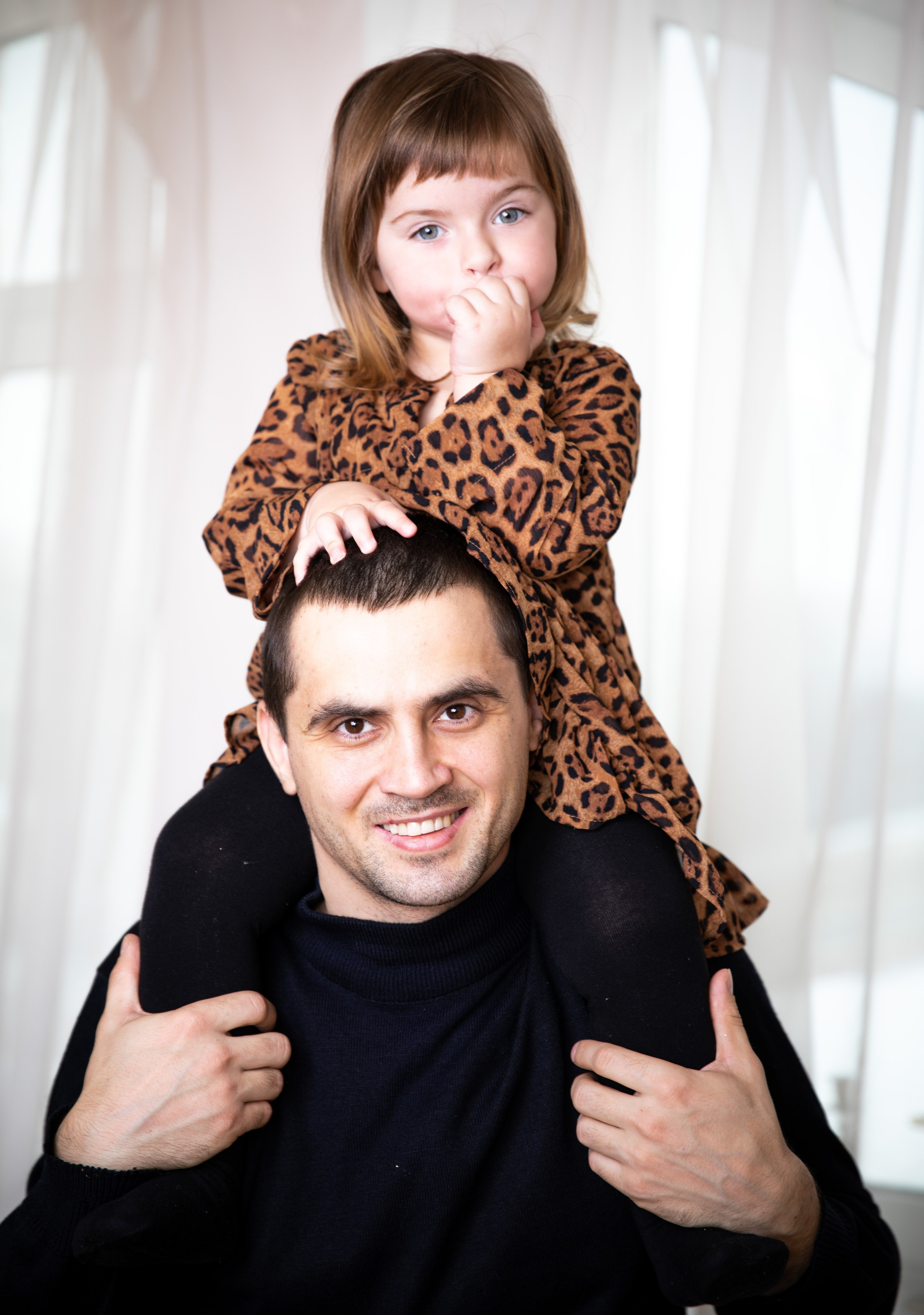 Father and daughter at a family photo shoot in the studio