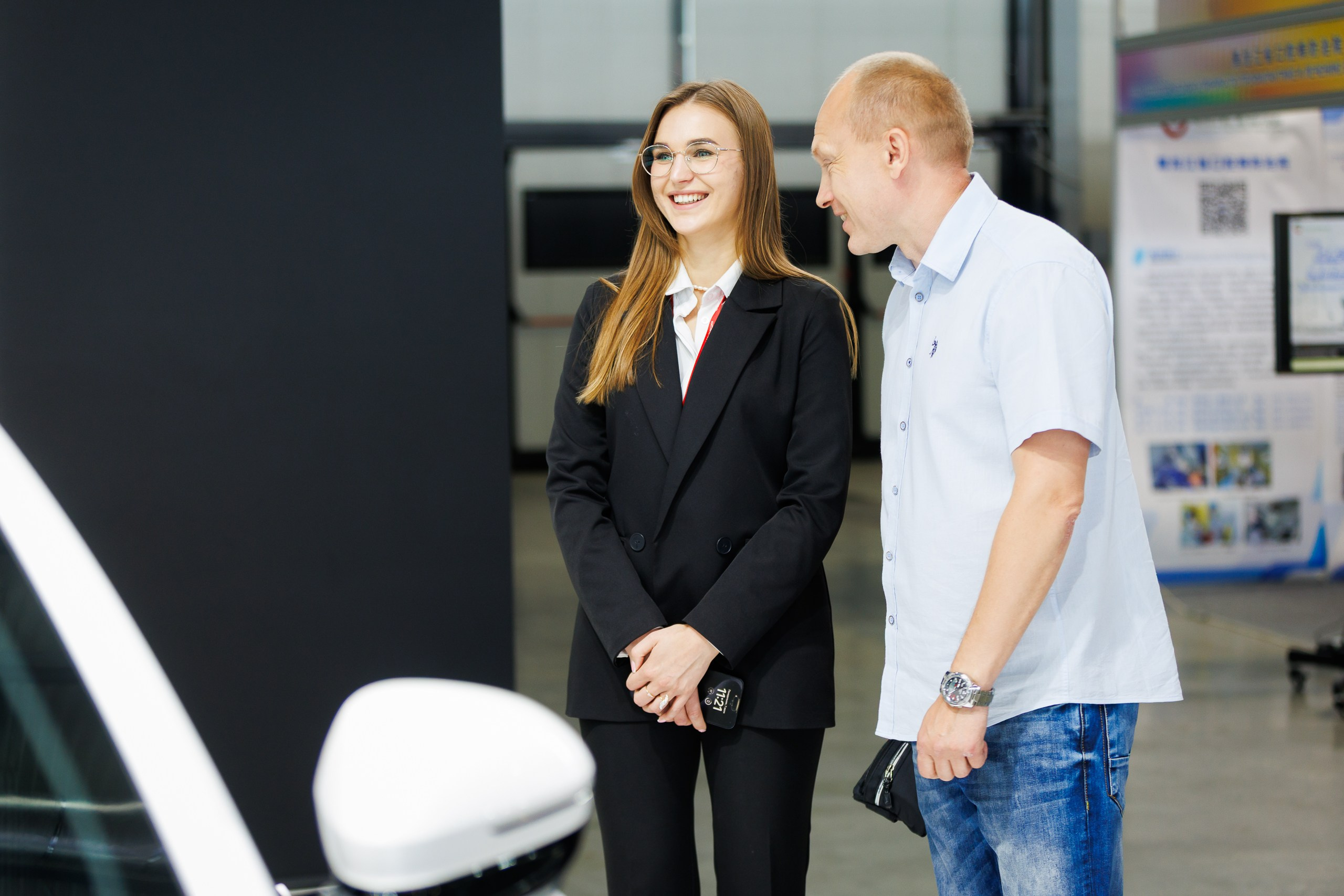  Сотрудник компании общается с клиентом у стенда, фоторепортаж