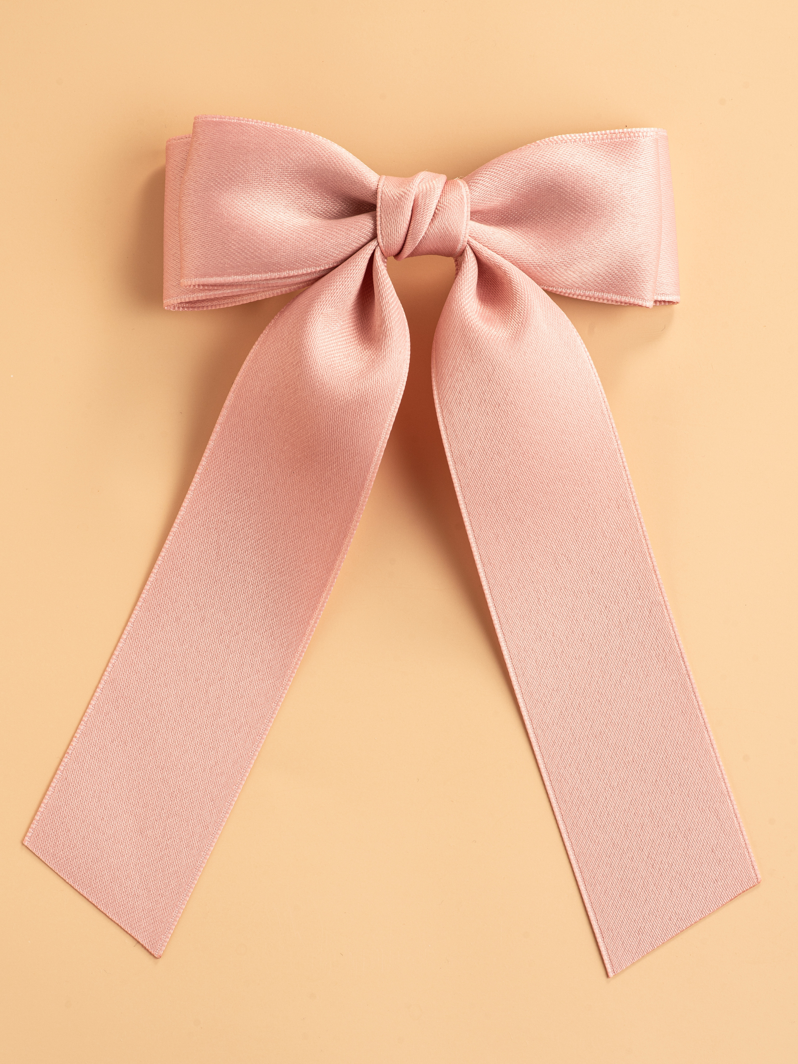 Каталожное фото розового бантика на бежевом фоне для Вайлдберриз