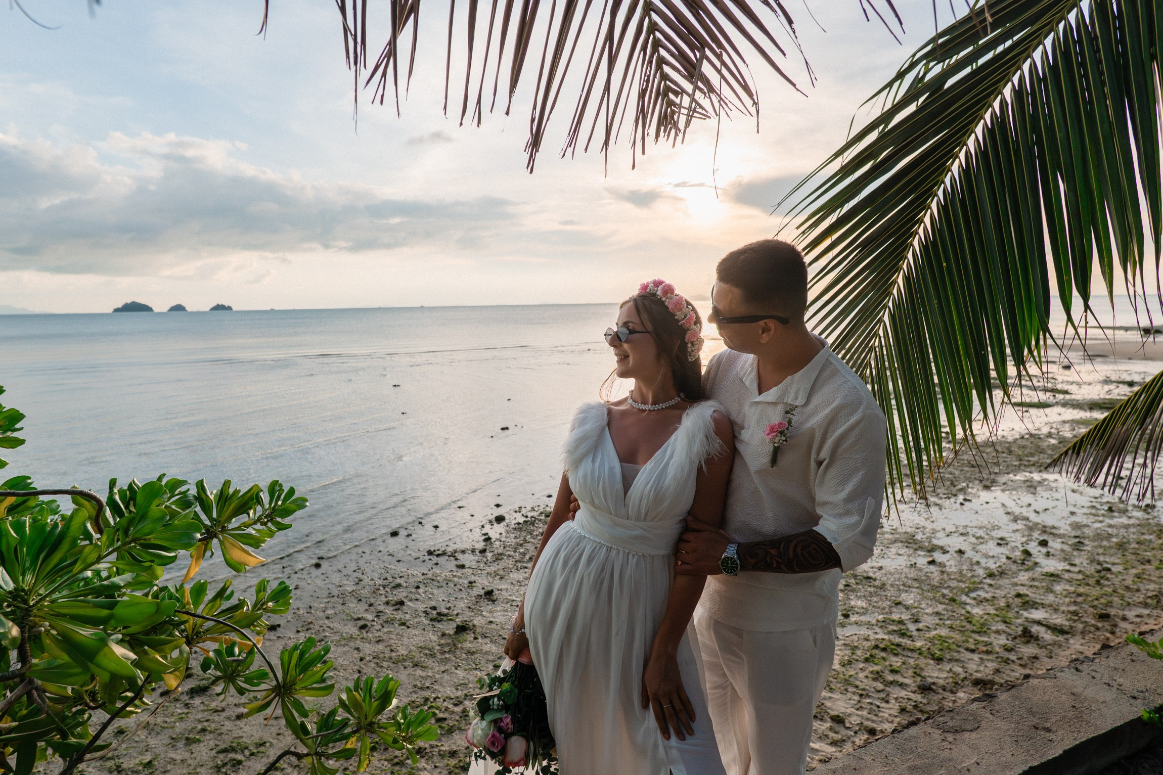 Bride and groom exchanging vows on a private sunset beach