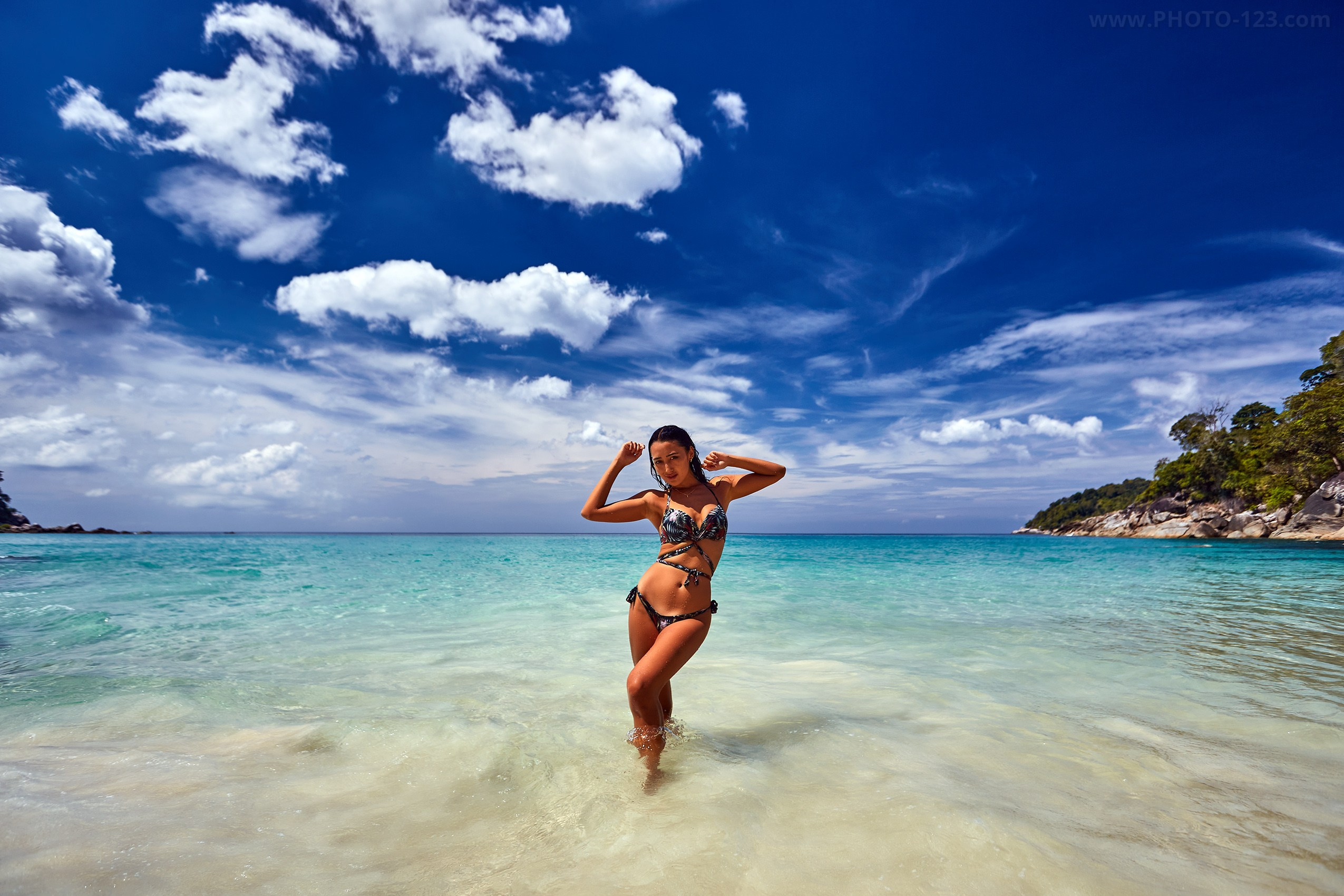 High-end swimwear portrait on the turquoise shoreline of Vietnam, captured by a photographer with 25 years of experience.