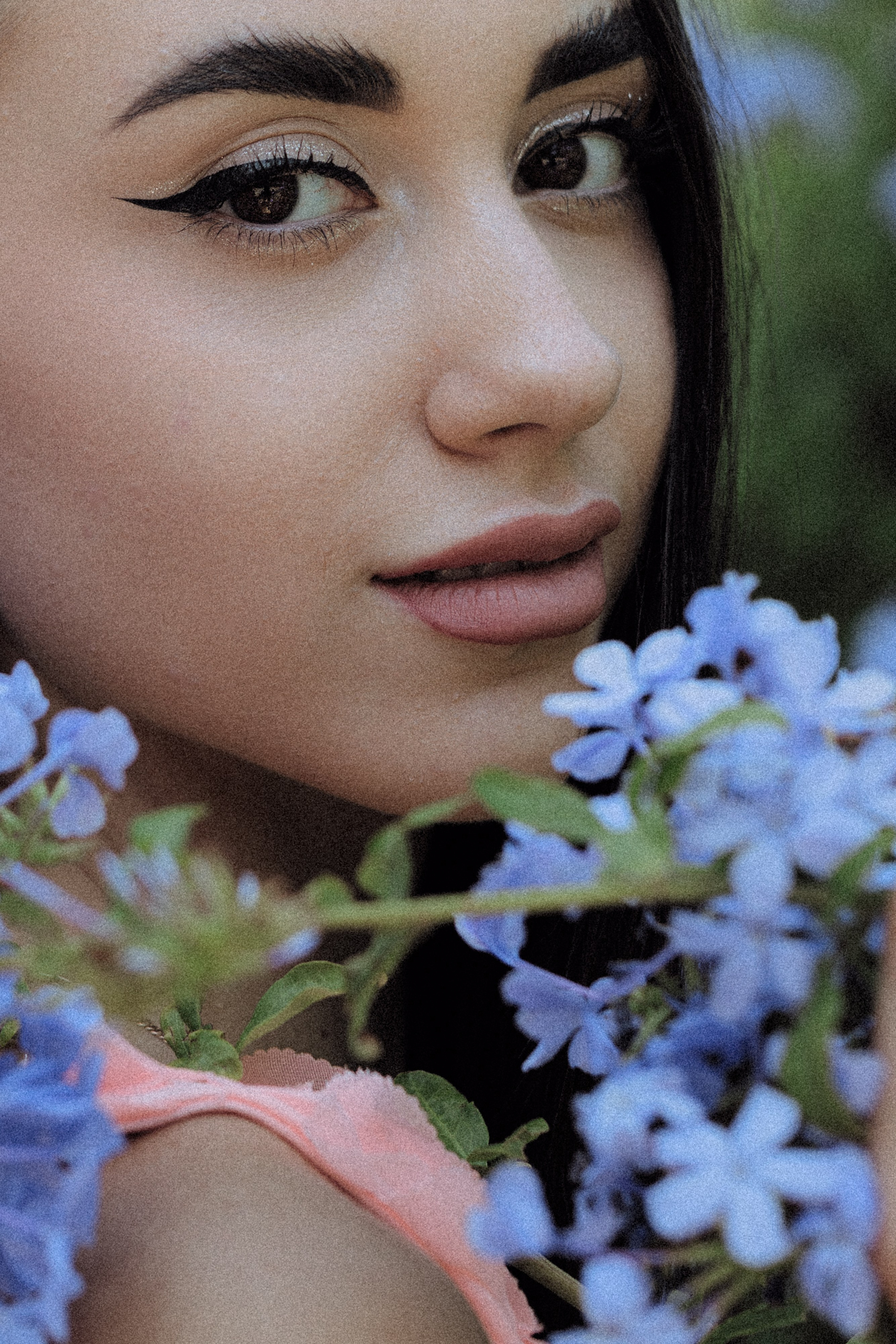 Graceful girl in a soft pink outfit posing by a decorative Barcelona doorway.