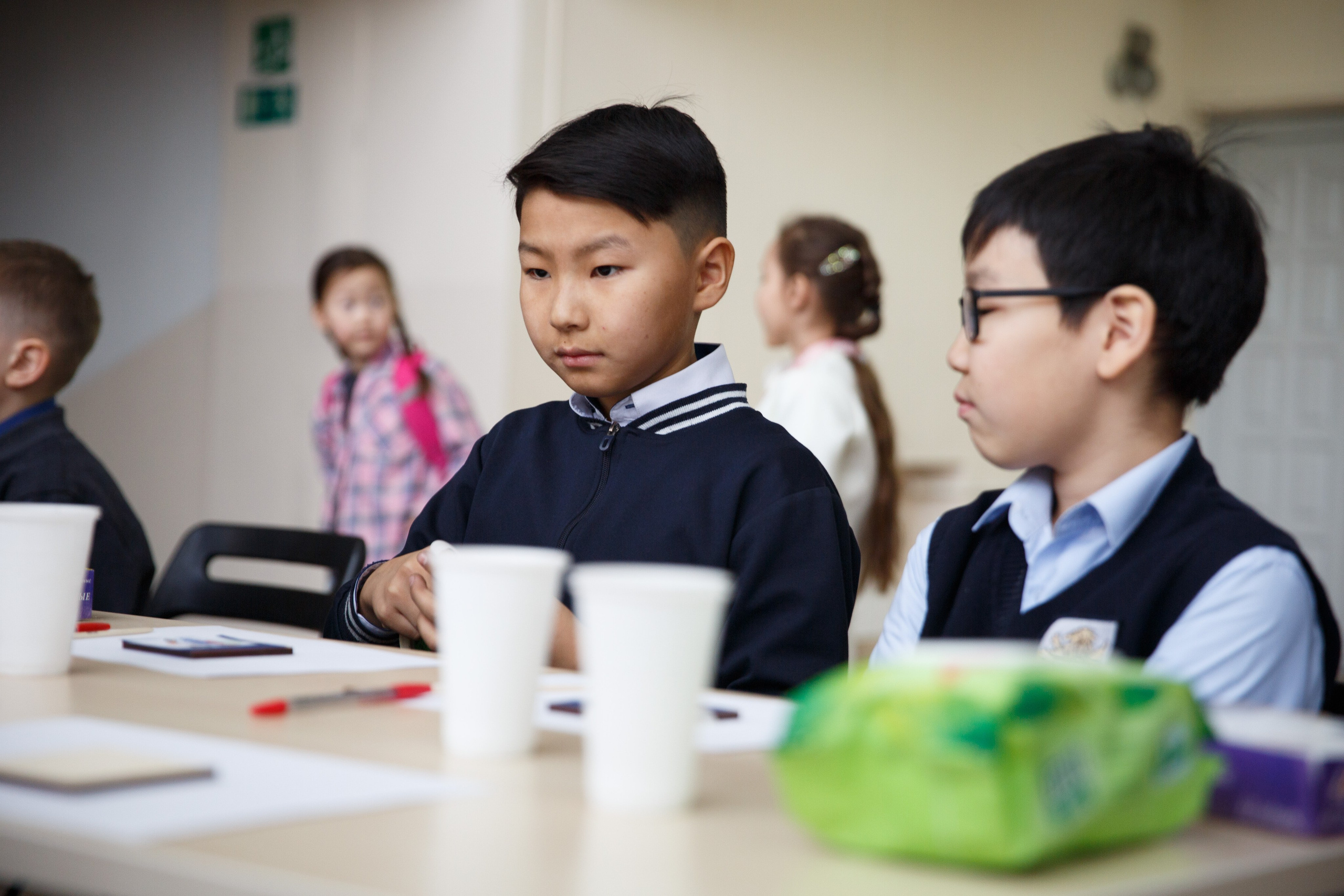 Ученики в белых рубашках обсуждают творческое задание.