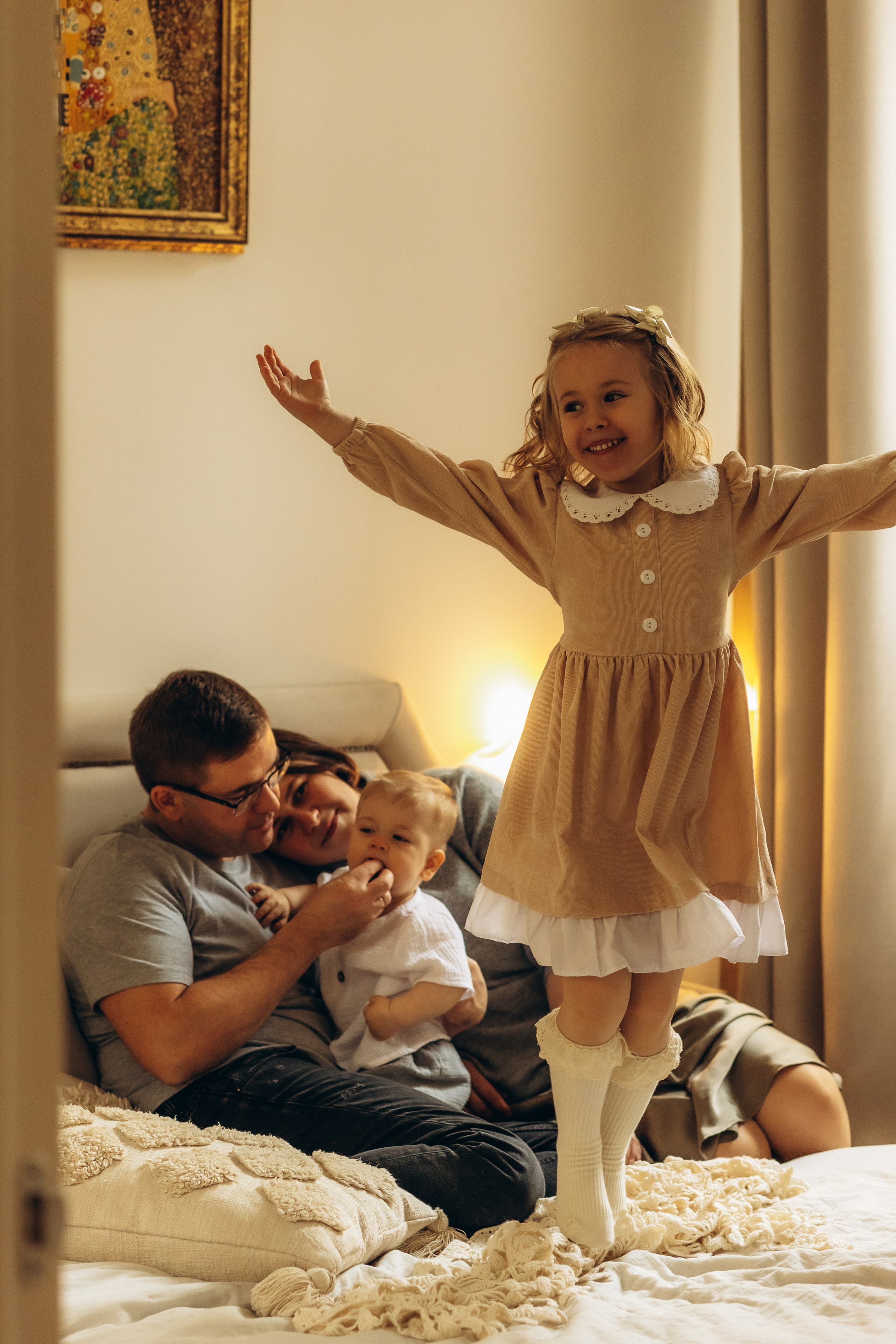 девочка прыгает на кровати на фотосъемке