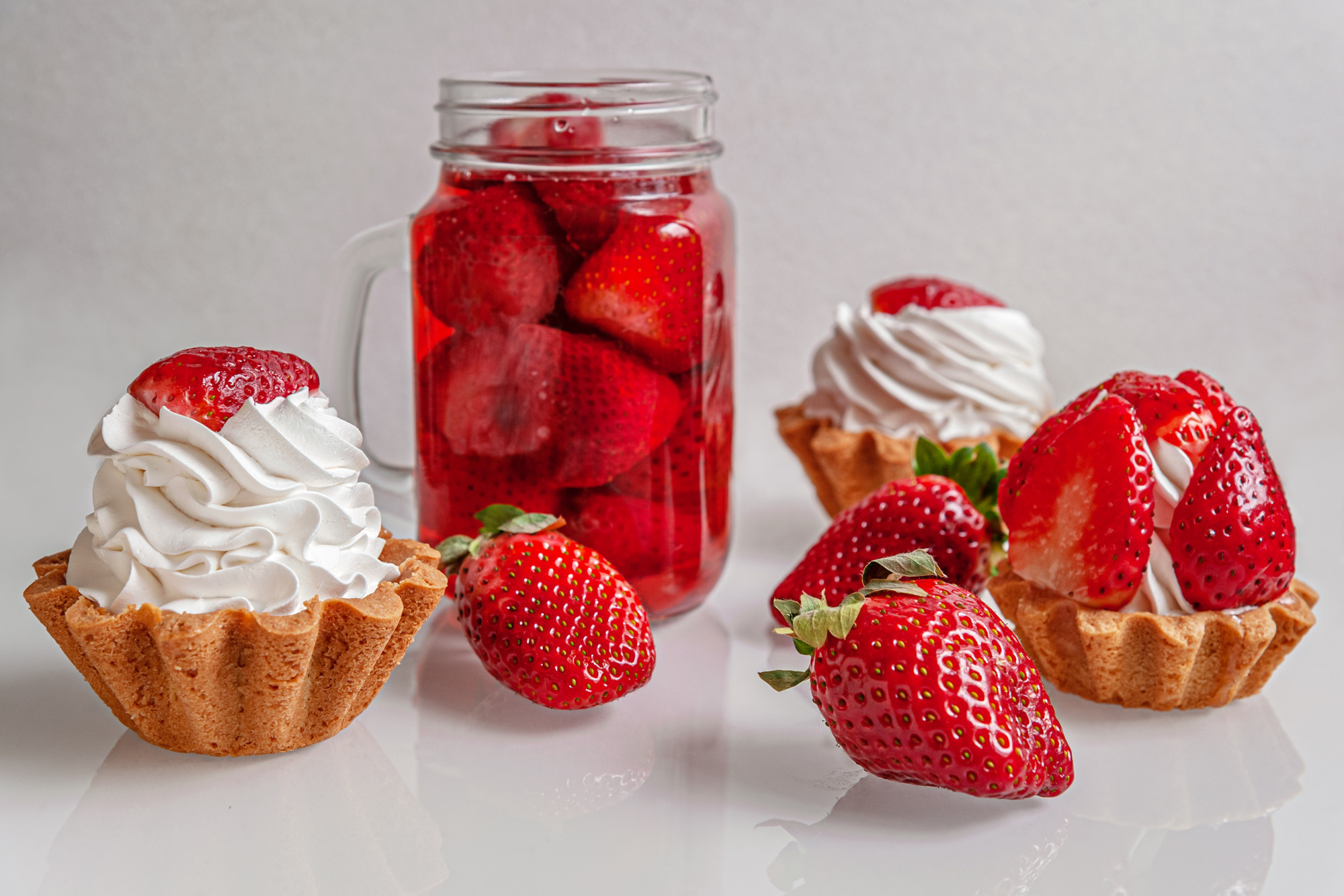 gourmet tartlets with whipped cream and cool strawberry beverage
