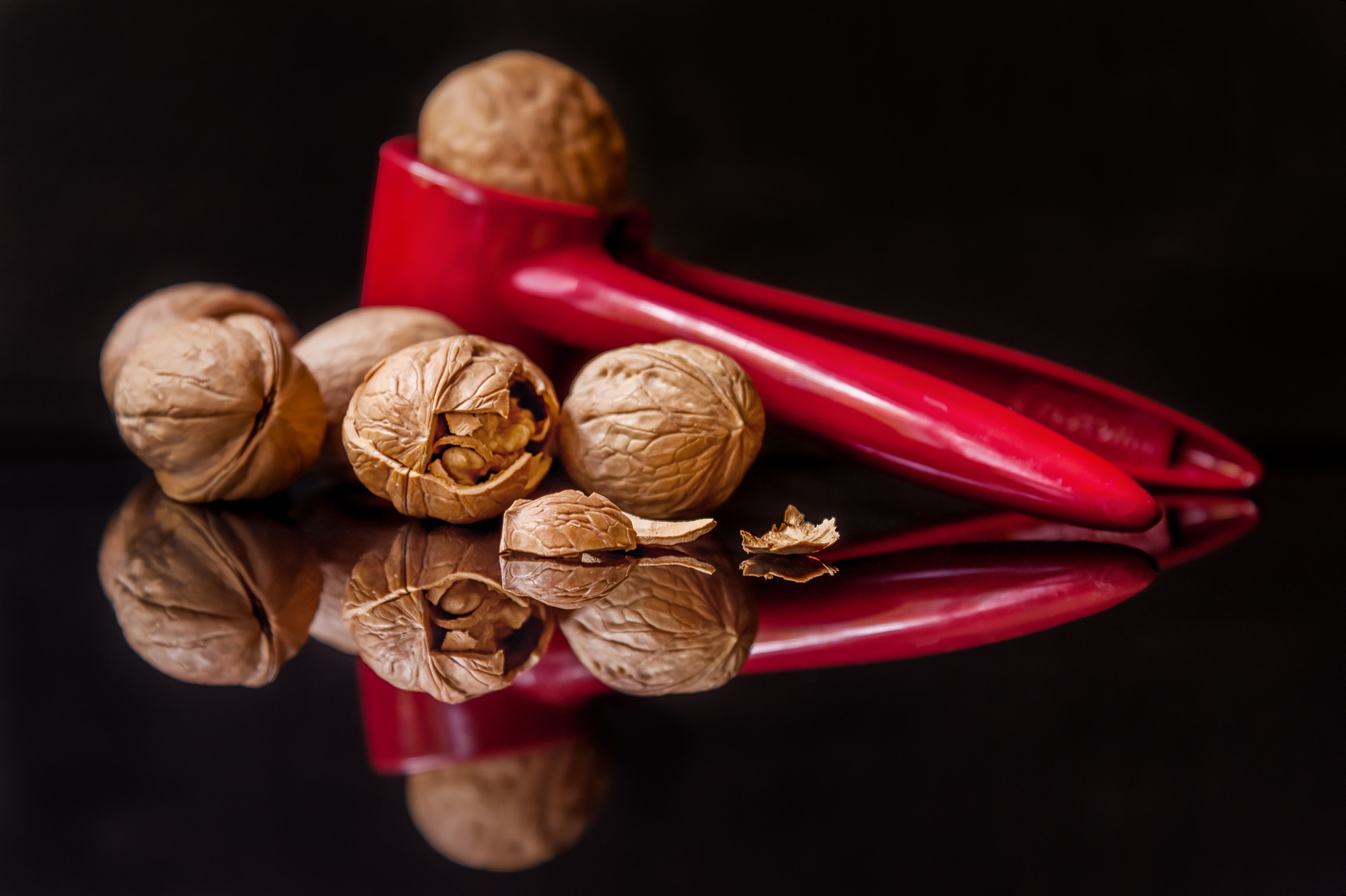 nutcracker and walnuts on a black glass 