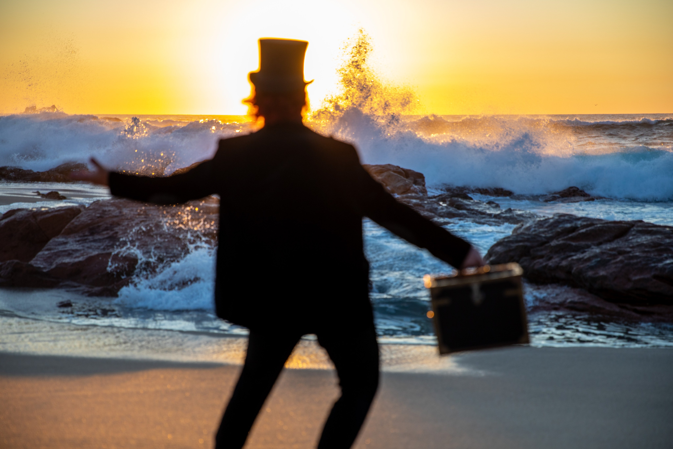 Magician and illusionist. Photo walk on the beach