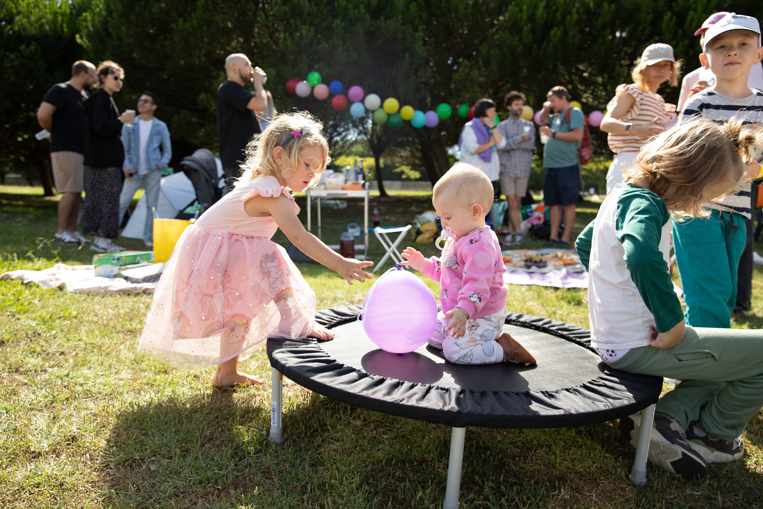 Children having fun with games and soap bubbles in the park. Birthday celebration photos