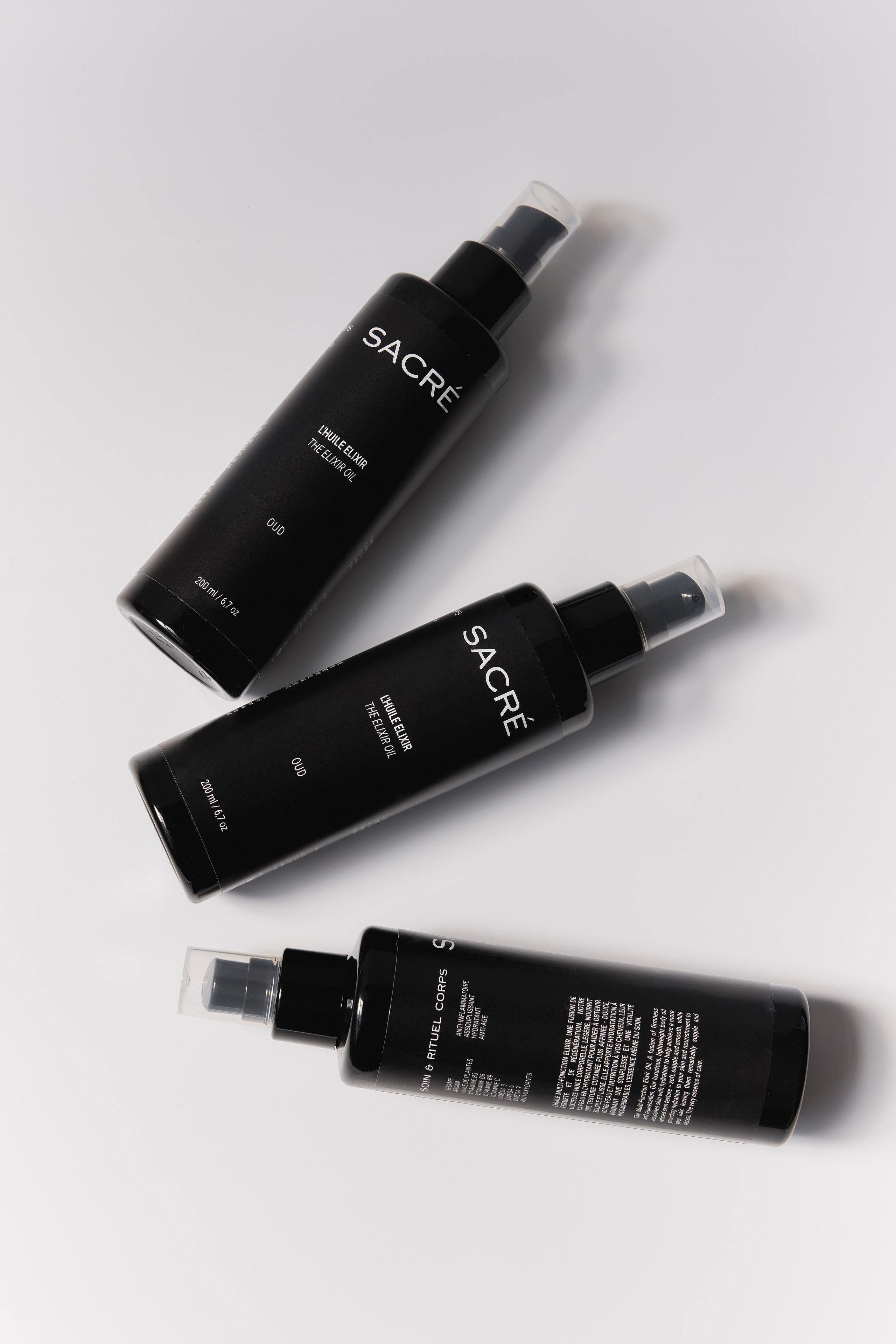 Luxury black skincare bottles arranged for a sleek, professional beauty product display.