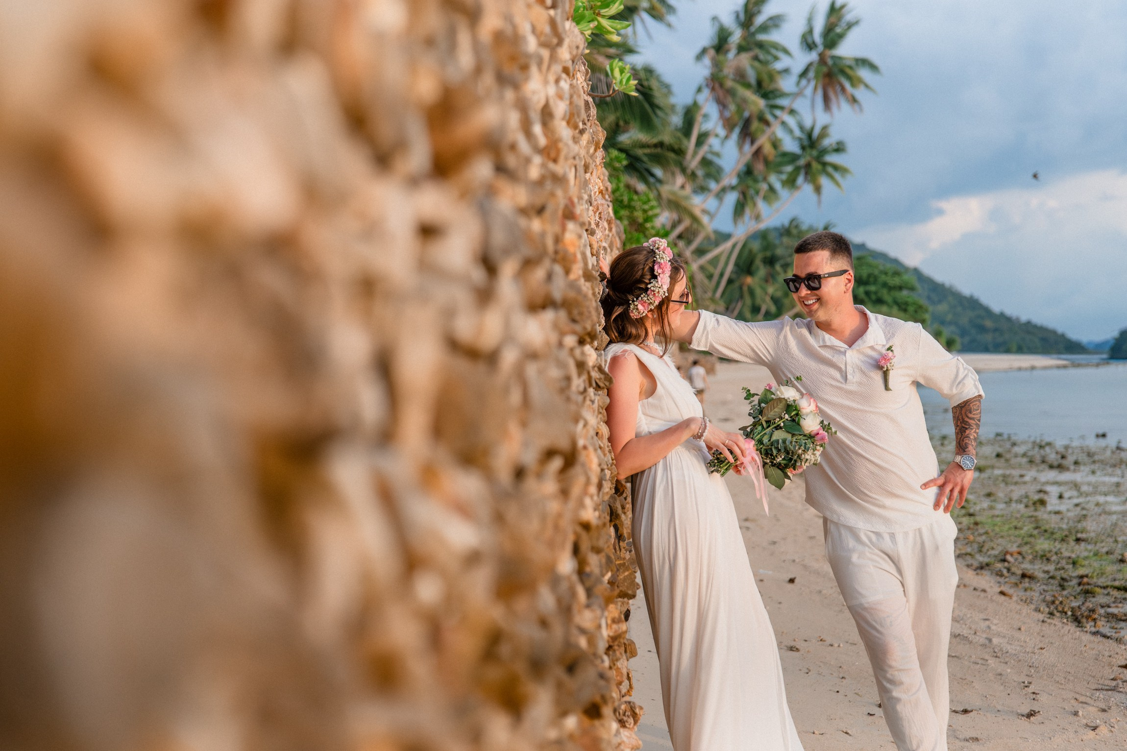 Bride and groom during a romantic beach wedding ceremony on Koh Samui, Thailand, surrounded by tropical scenery and ocean views