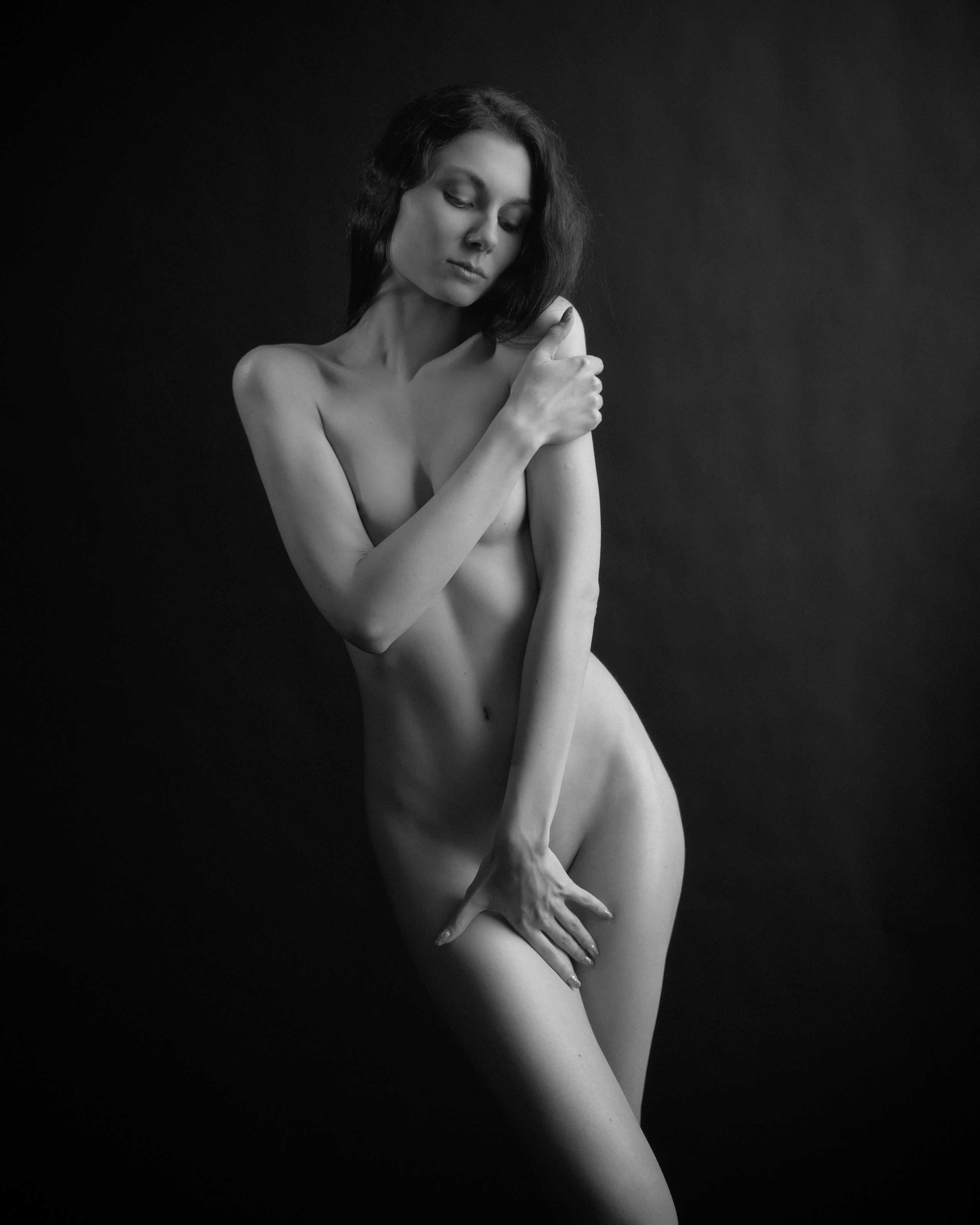A series of creative photos taken in the studio. The photos are made in the nude genre. Black and white photo