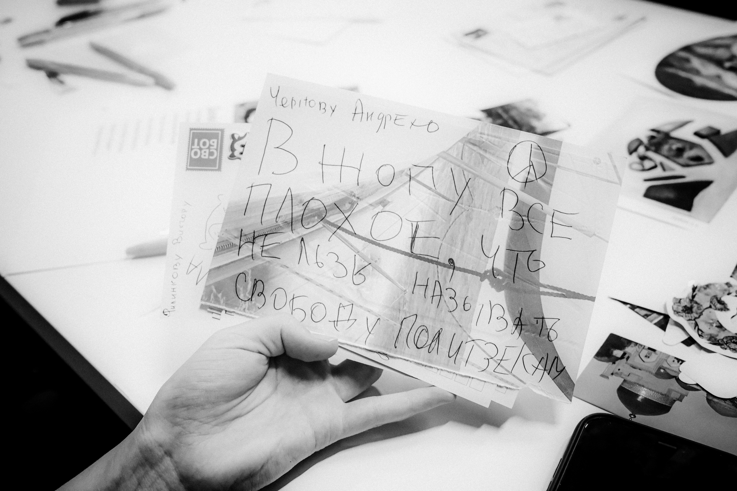 Signing postcards for political prisoners, September 2022. Photographer in Israel Alice Milchin