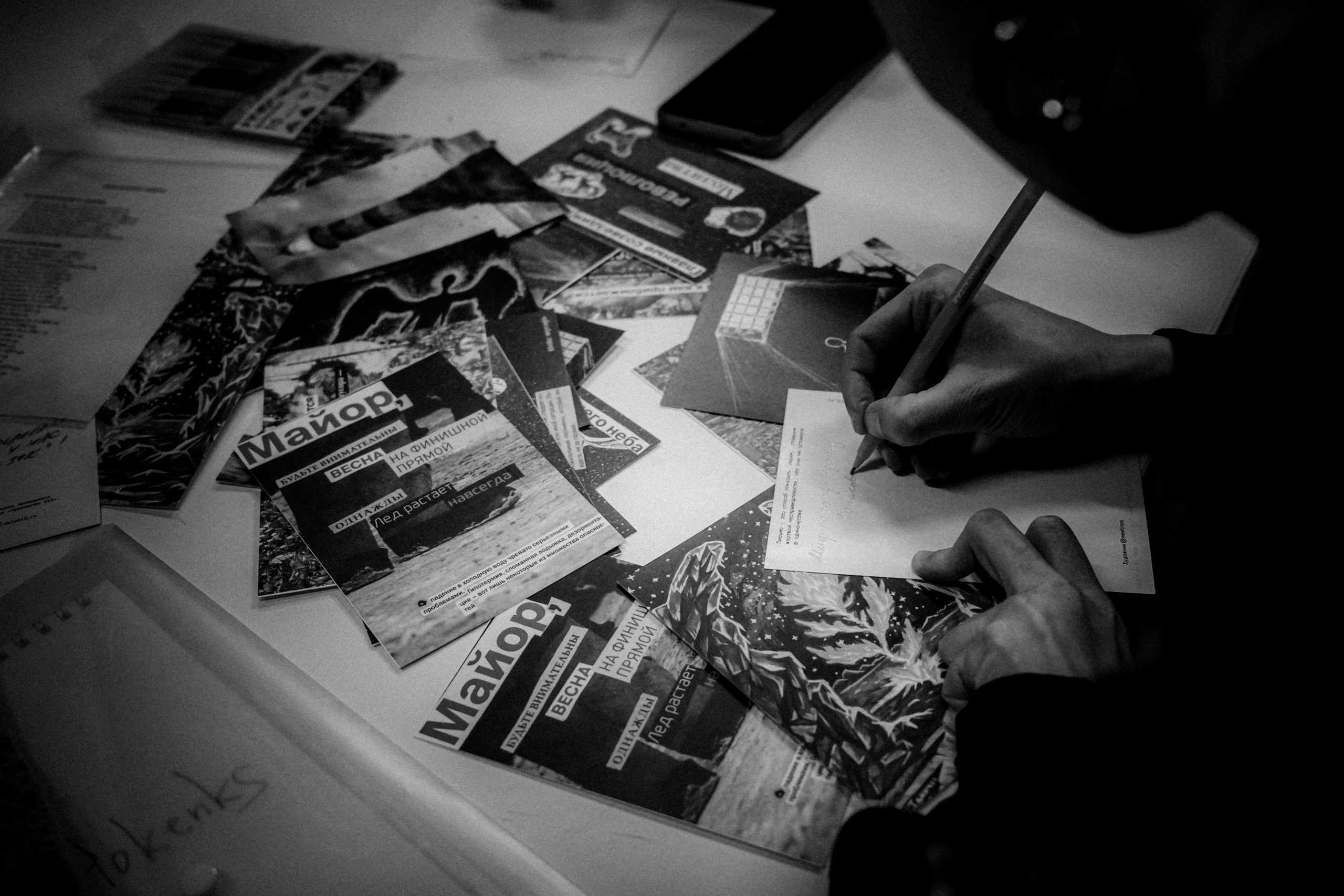 Signing postcards for political prisoners, February 2022. Photographer in Israel Alice Milchin