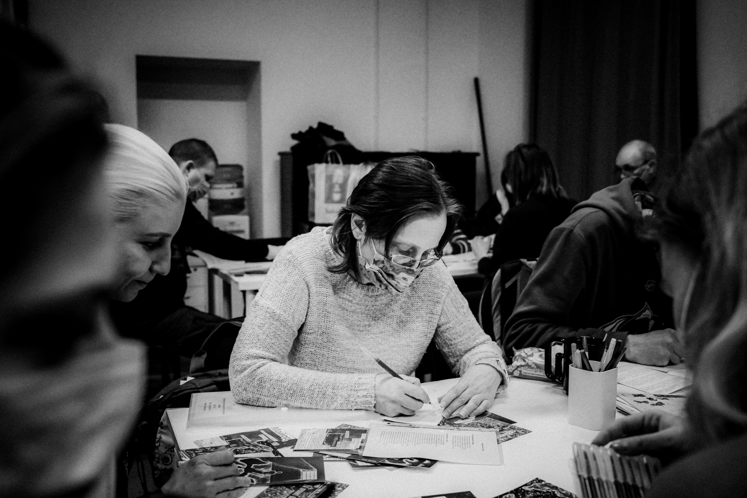 Signing postcards for political prisoners, February 2022. Photographer in Israel Alice Milchin