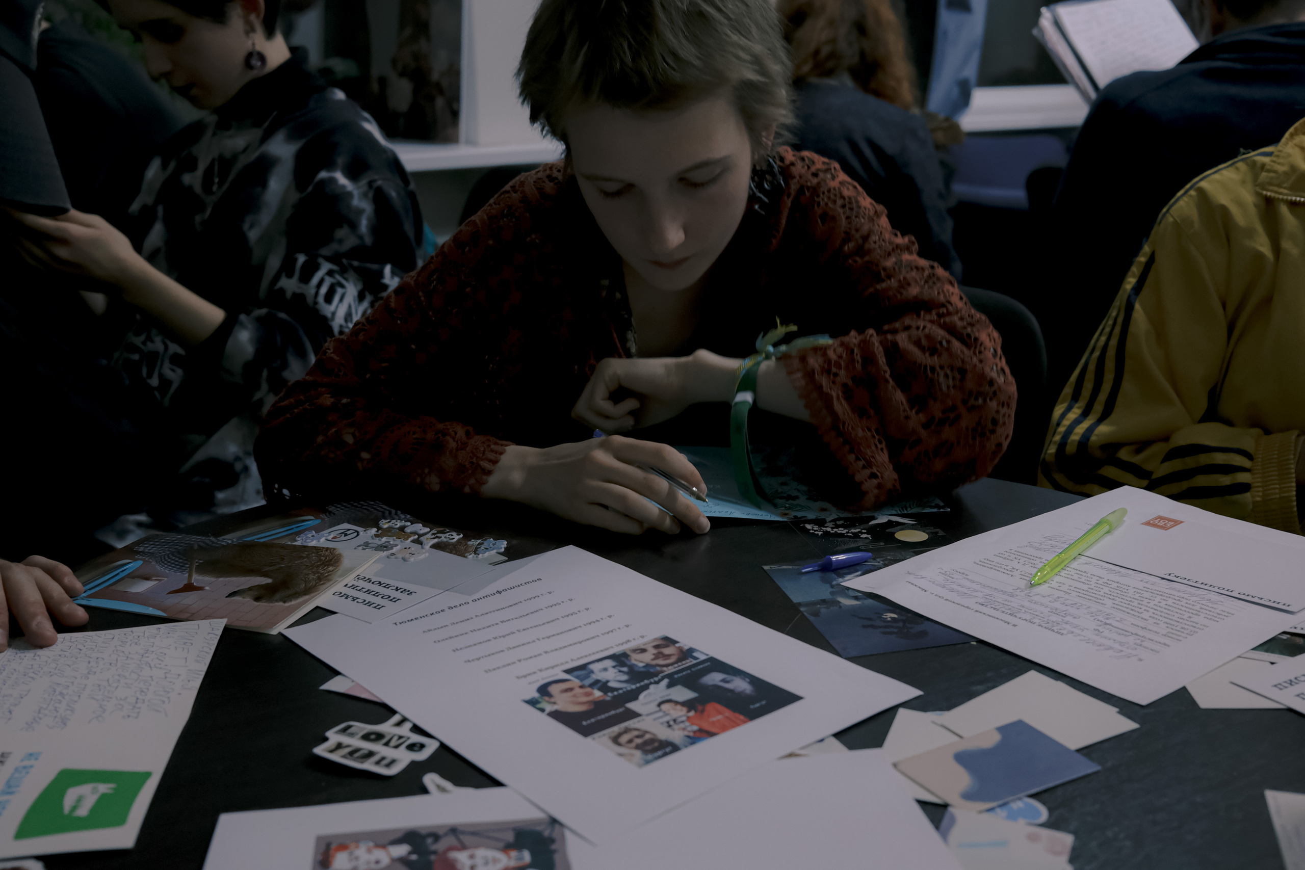 Signing postcards for political prisoners, September 2022. Photographer in Israel Alice Milchin