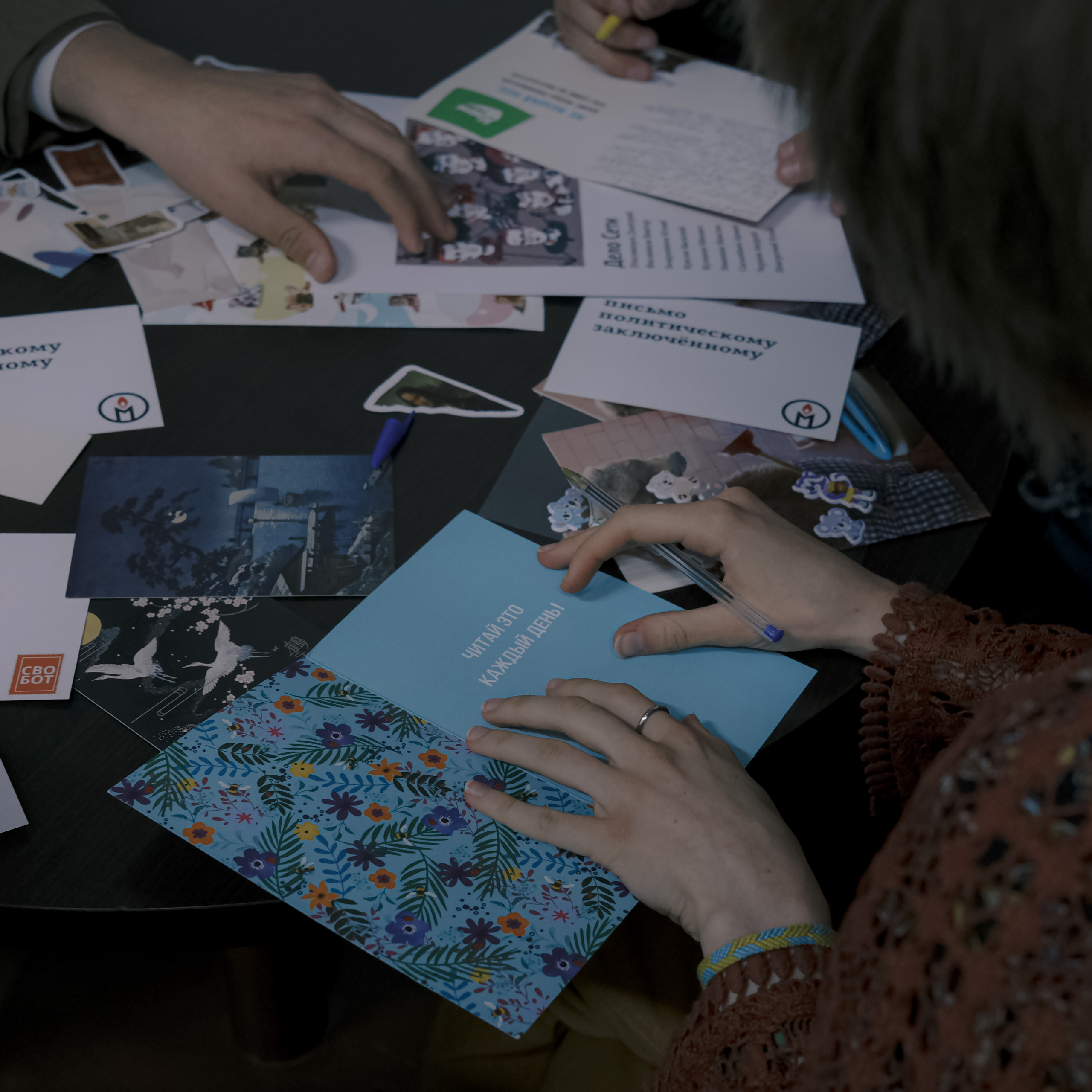 Signing postcards for political prisoners, September 2022. Photographer in Israel Alice Milchin