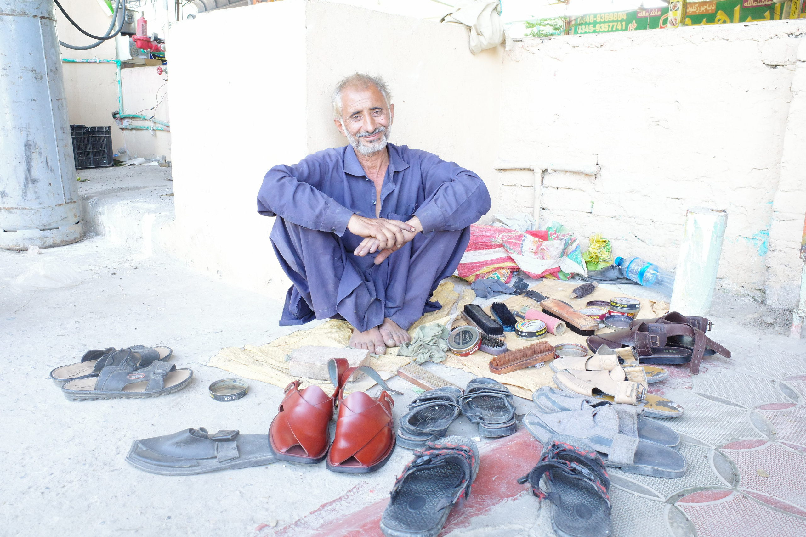 A rainbow-colored shoe shiner greets visitors at a roadside cafe on the road to Peshawar