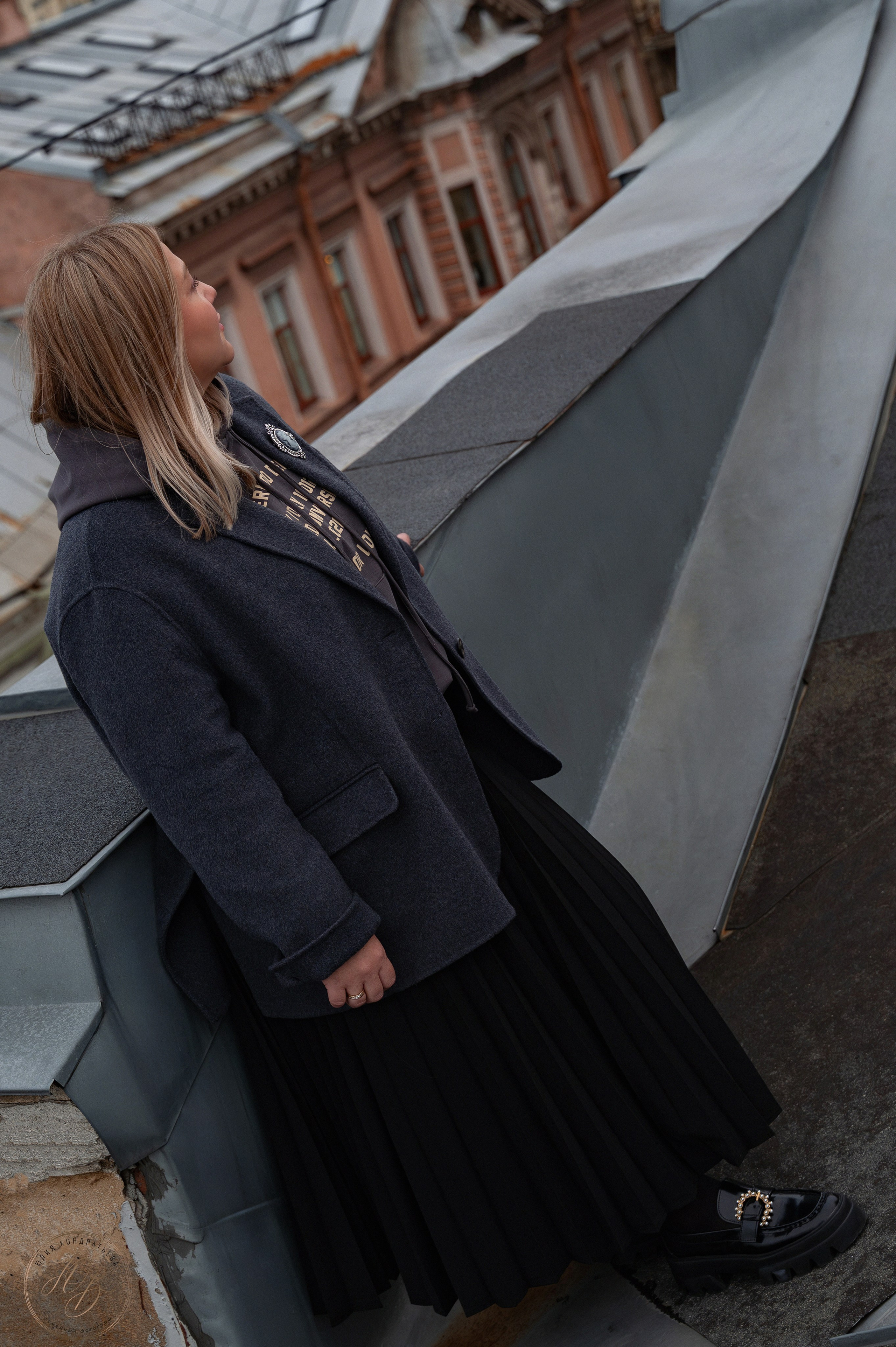 st-petersburg-woman-in-coat-and-pleated-skirt-rooftop-view