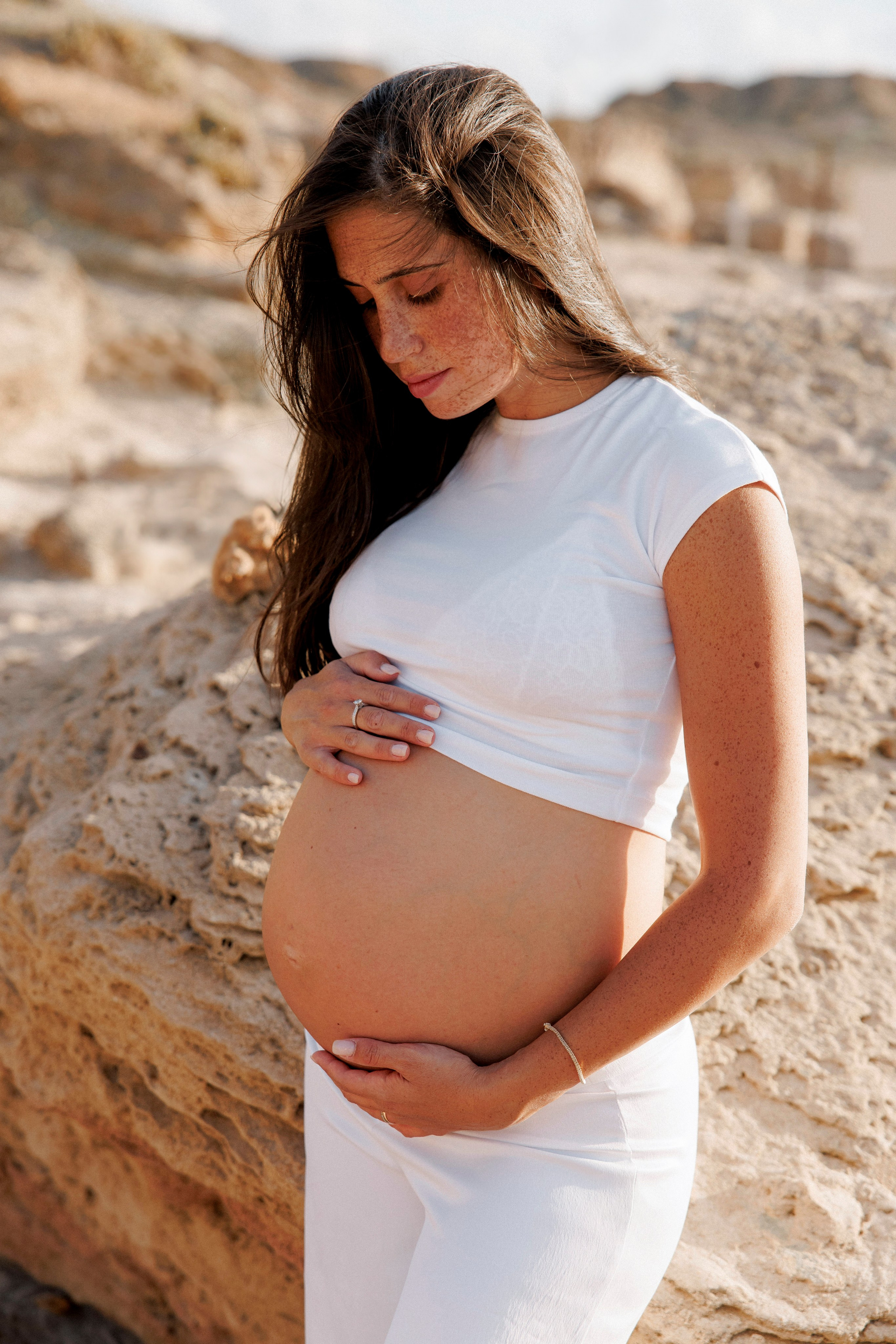 Pregnancy photoshoot near the sea. Wedding and family photographer