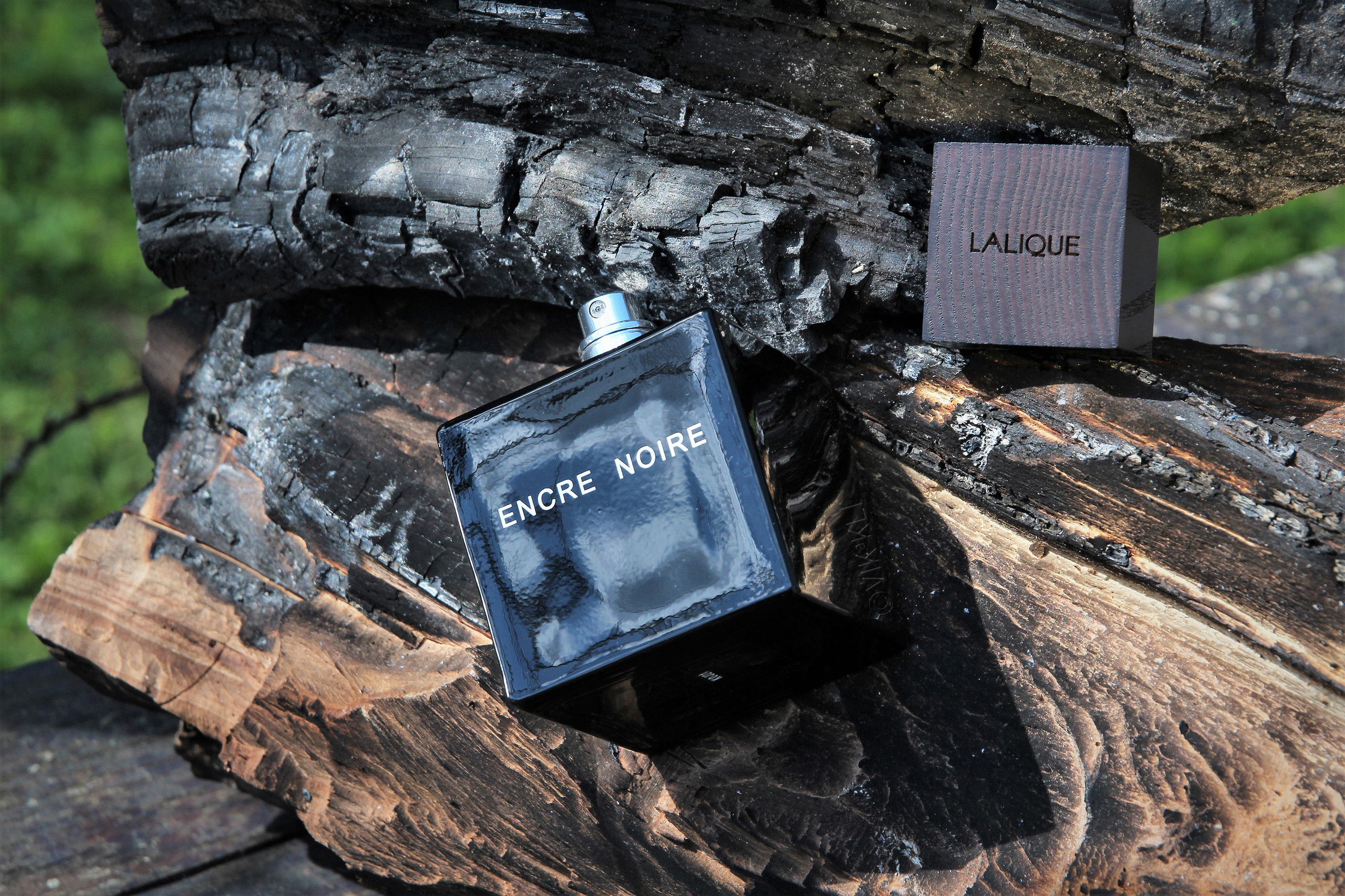 Духи Lalique Encre Noire на древесине. Имиджевое фото.