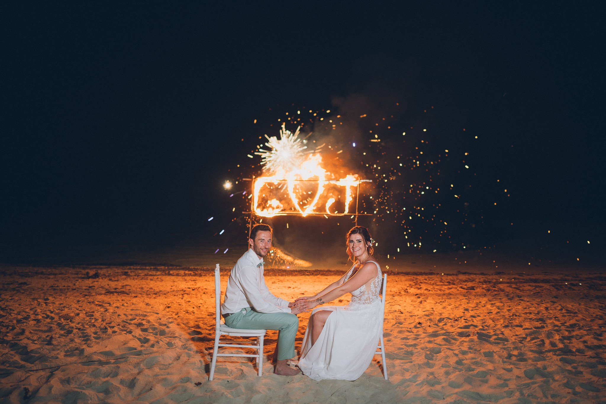 Spectacular fire show performance during a beach wedding reception in Koh Samui